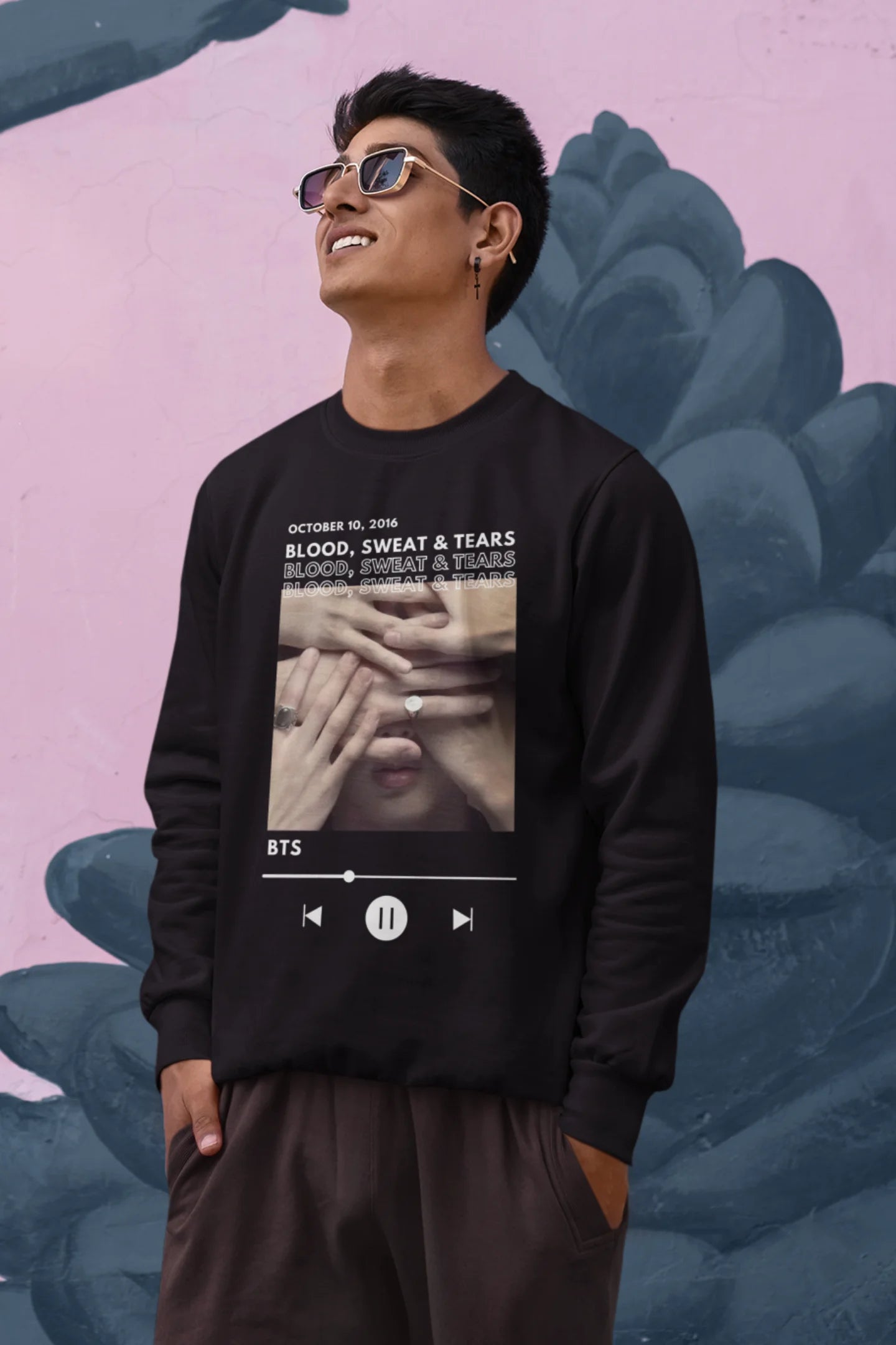 First front view of a male model wearing a black sweatshirt featuring a design inspired by BTS's music video "Blood, Sweat & Tears." Ideal for BTS fans (ARMY) who want to celebrate this iconic era.