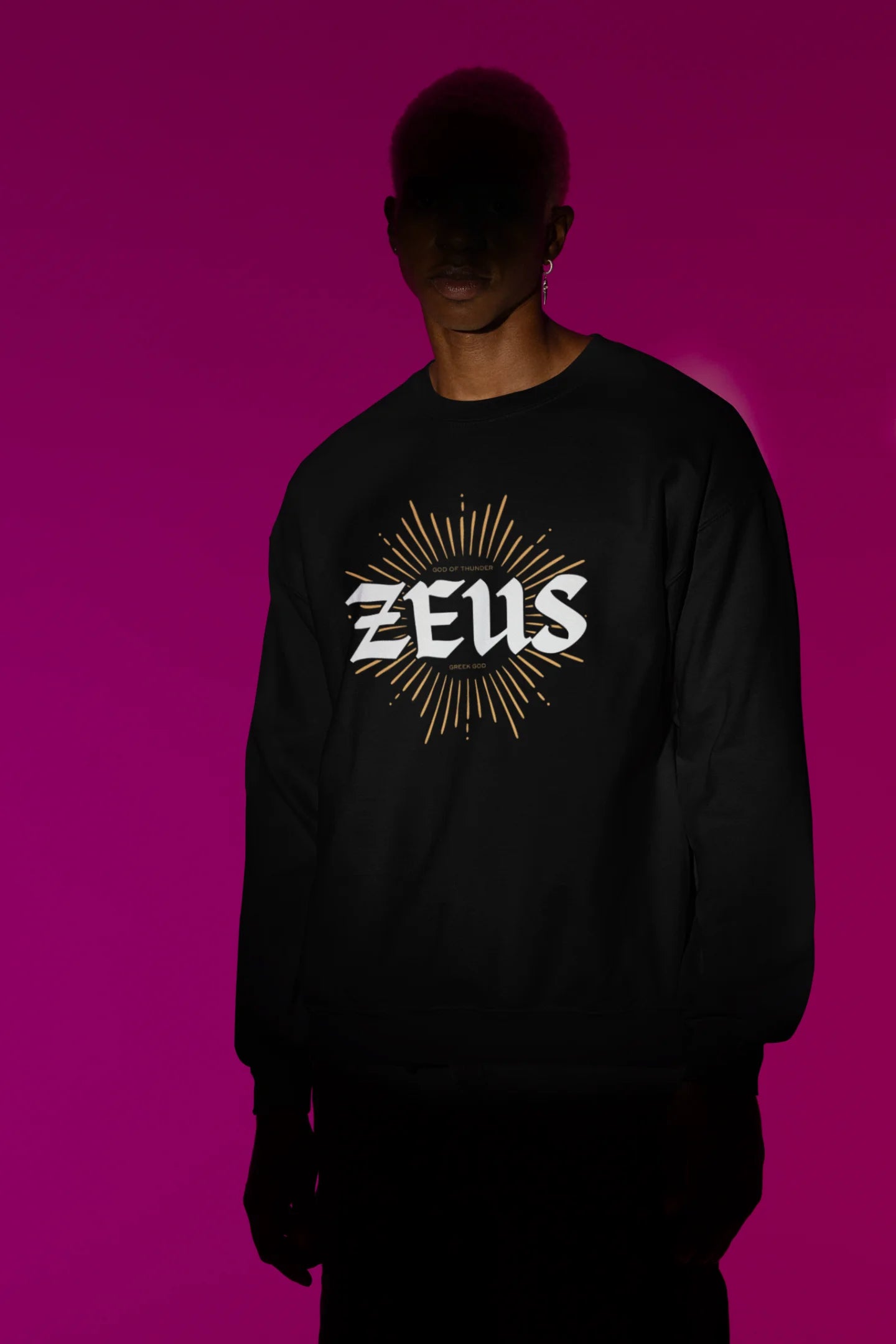 First front view of a male model wearing a brutalist-inspired black sweatshirt with a stylized image of Zeus, king of the gods, in a concrete-like design.