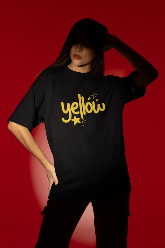 First front view of a female model wearing a black oversized t-shirt with the "Yellow" album artwork by Coldplay.