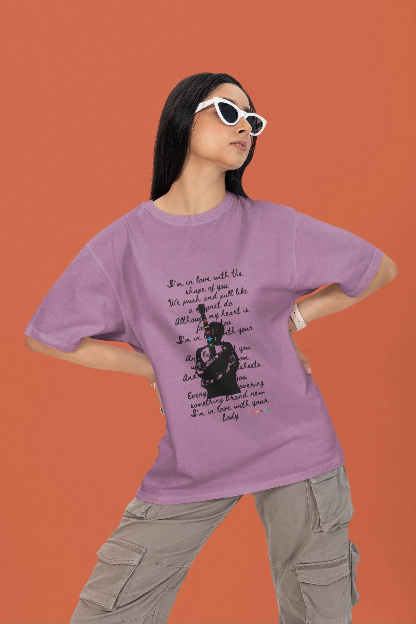 2nd front view of a female model wearing a dirty purple oversized t-shirt featuring a design inspired by Ed Sheeran's concerts, related to the song "Shape of You."