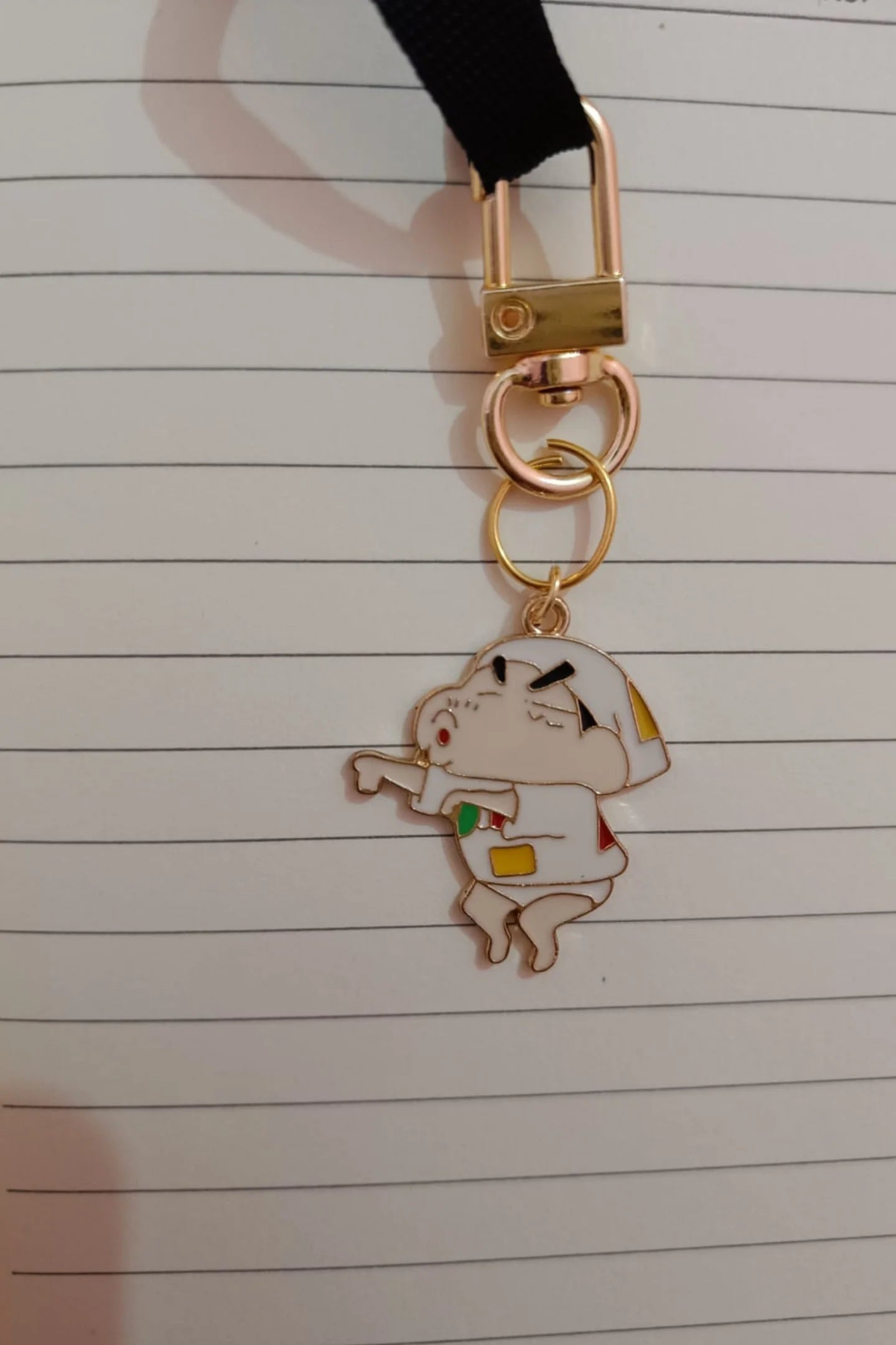 Third view of a keychain featuring a mischievous Shinchan design. Perfect for Shinchan fans.