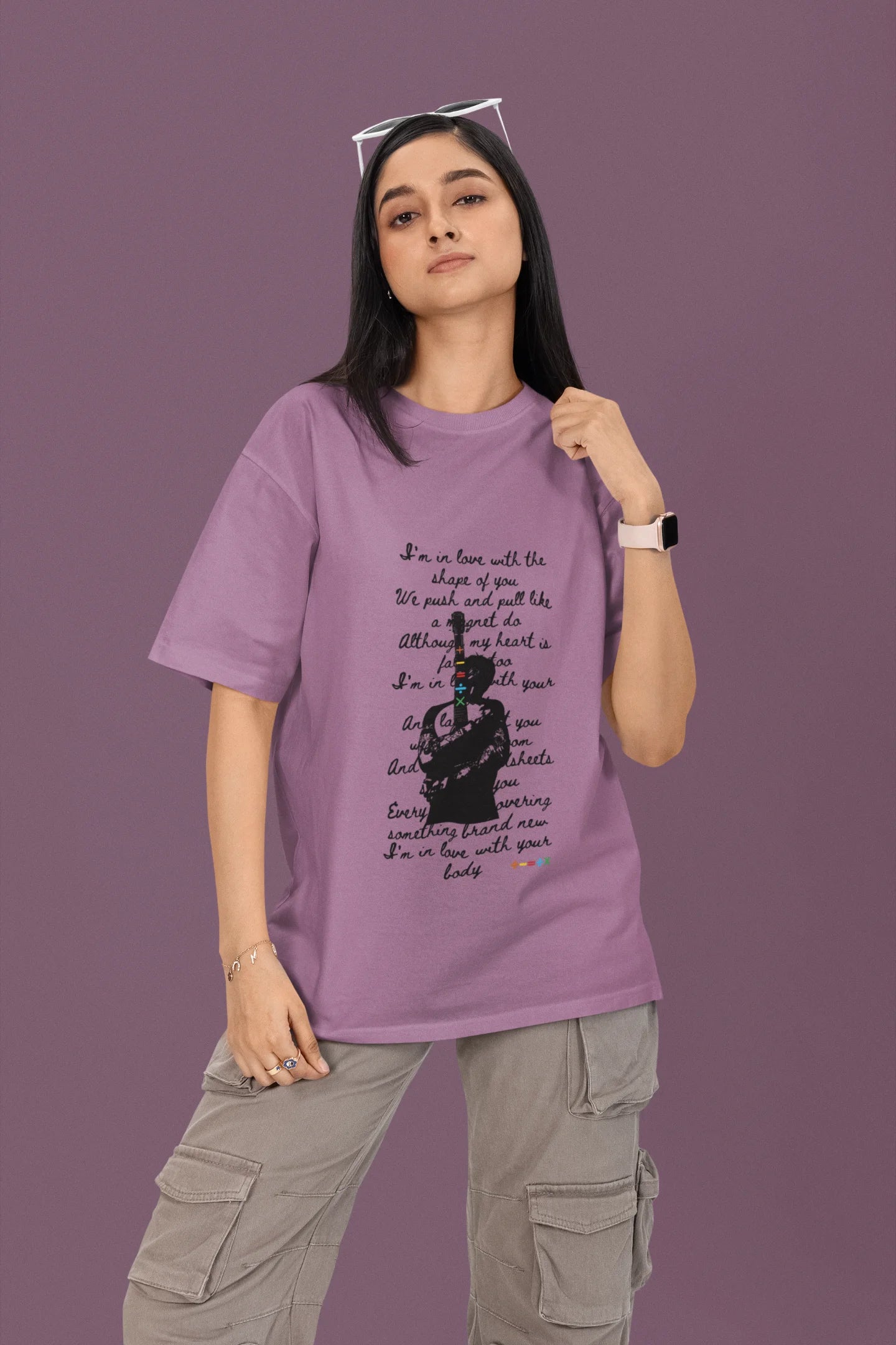 First front view of a female model wearing a dirty purple oversized t-shirt featuring a design inspired by Ed Sheeran's concerts, related to the song "Shape of You."
