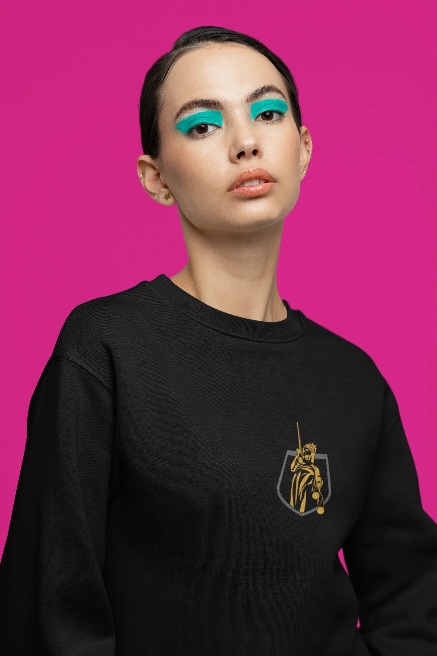 Second front view of a female model wearing a black sweatshirt with a brutalist Lady Justice statue design.