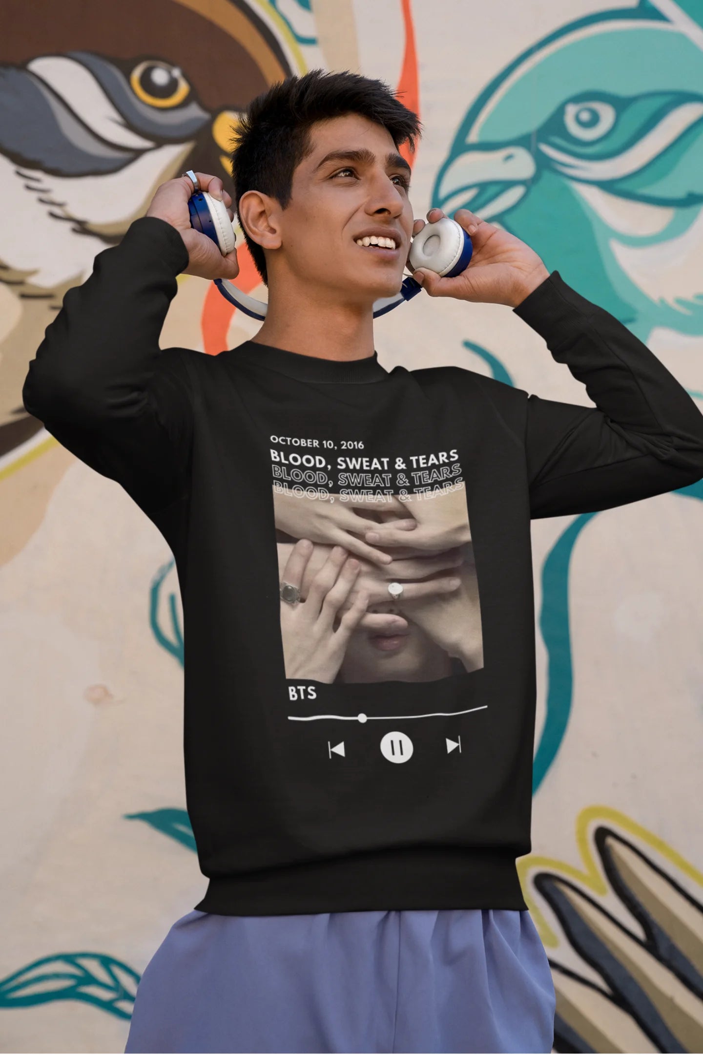 Second front view of a male model wearing a black sweatshirt featuring a design inspired by BTS's music video "Blood, Sweat & Tears." Ideal for BTS fans (ARMY) who want to celebrate this iconic era.