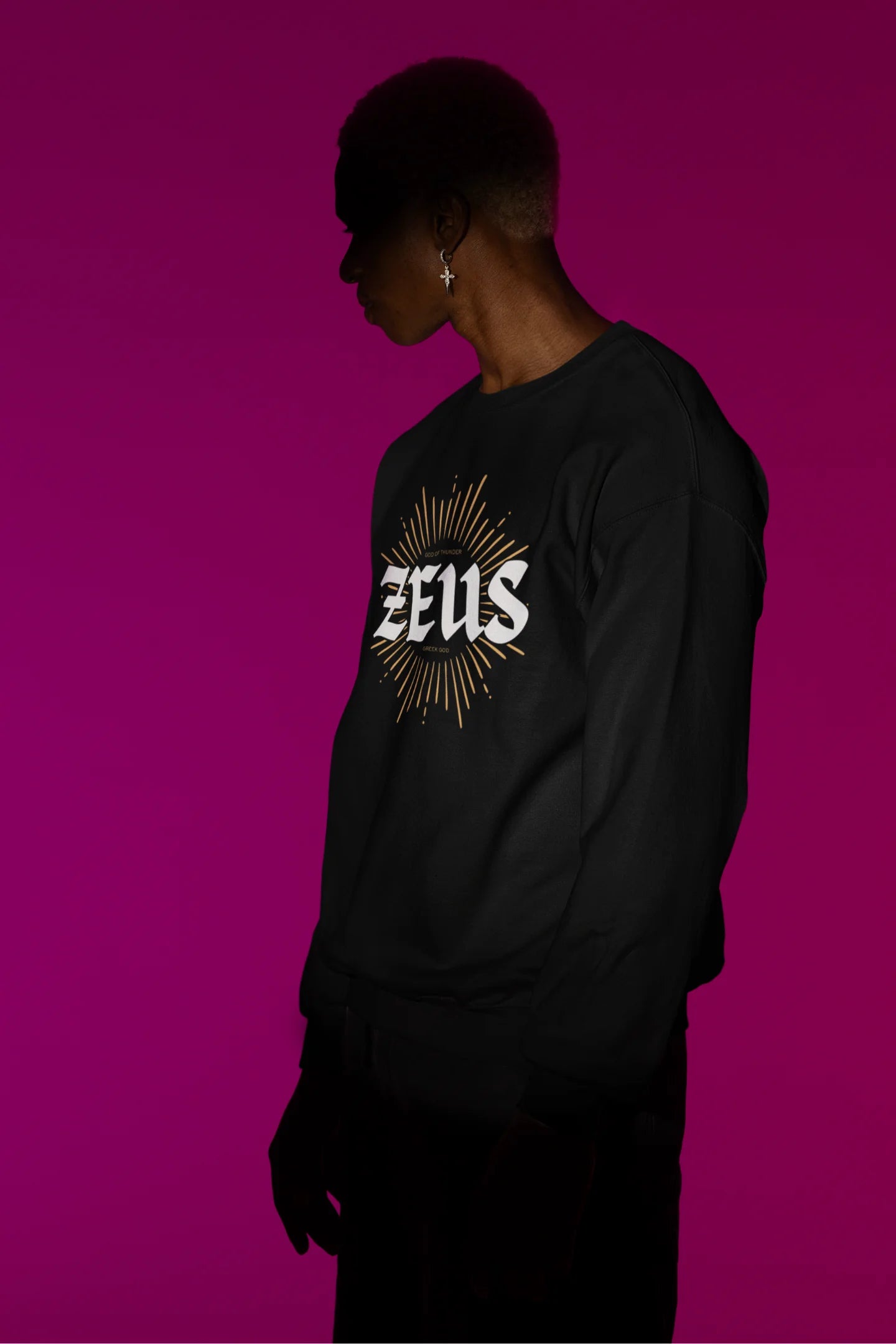 Second front view of a male model wearing a brutalist-inspired black sweatshirt with a stylized image of Zeus, king of the gods, in a concrete-like design.