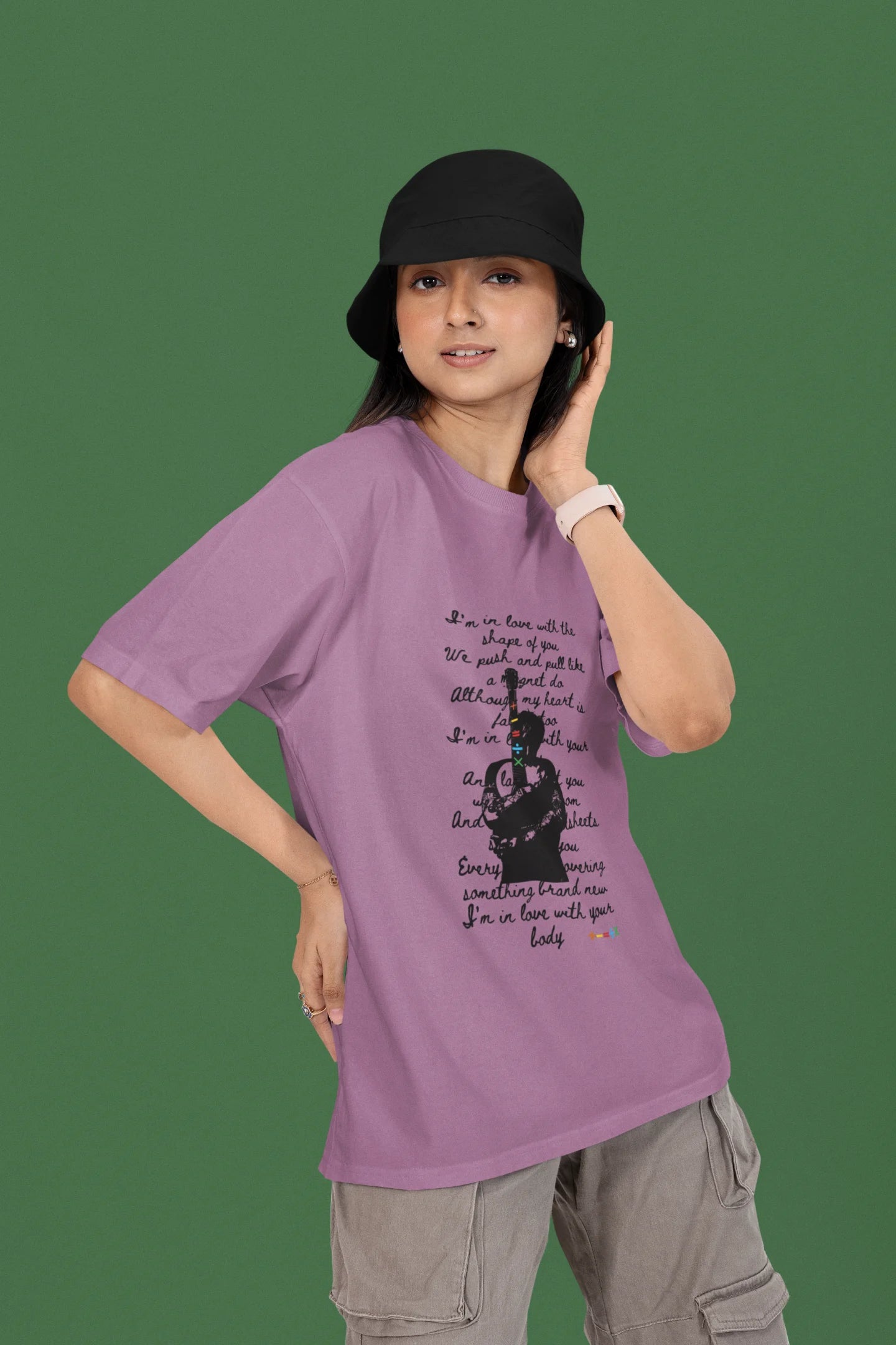 3rd front view of a female model wearing a dirty purple oversized t-shirt featuring a design inspired by Ed Sheeran's concerts, related to the song "Shape of You."