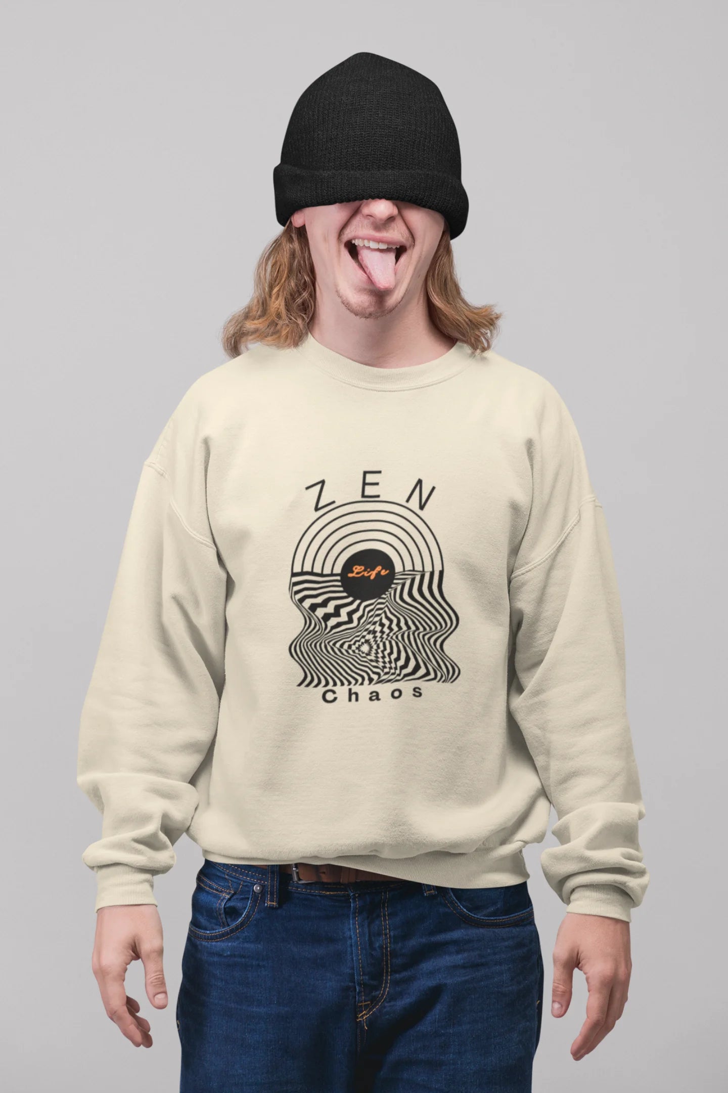 2nd front view of a male model wearing an cream sweatshirt featuring an aesthetic design of a setting sun and crashing waves with the text "Zen & Chaos" above it. Ideal for those who love philosophical themes and visually striking clothing.