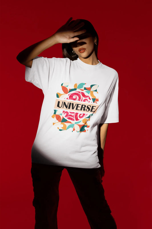 Second front view of a female model wearing an off-white oversized t-shirt with a cosmic Universe design inspired by Coldplay.