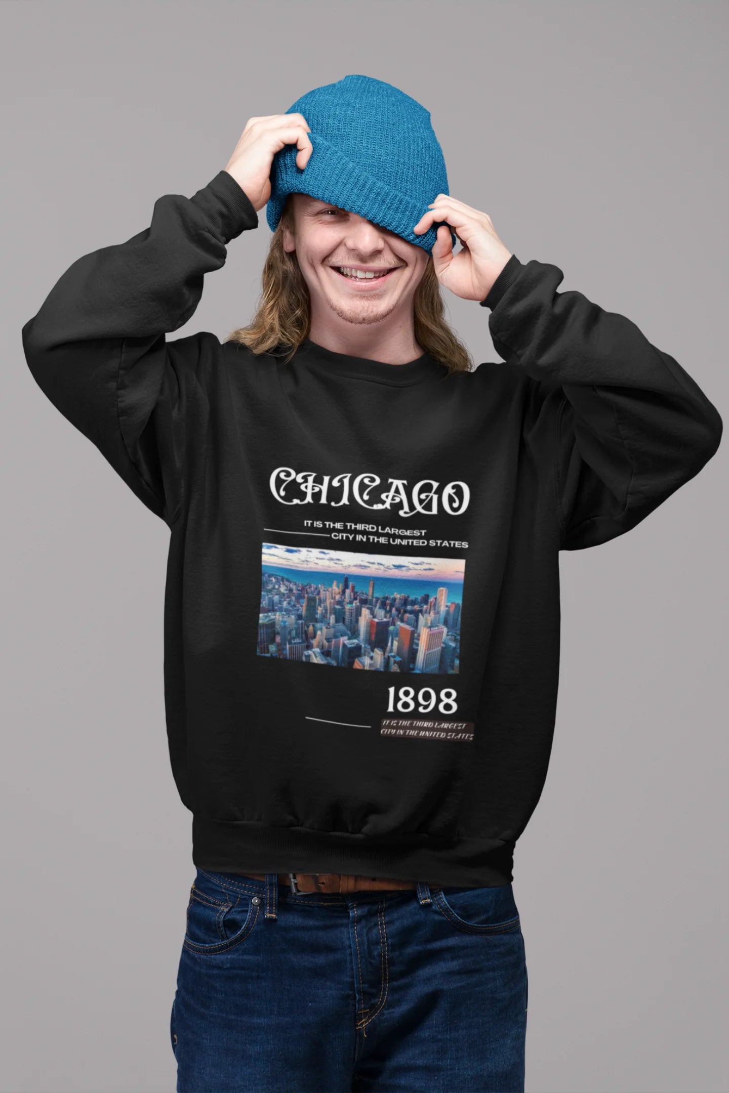 2nd front view of male model wearing a black sweatshirt with a Chicago skyline design, offering a relaxed urban aesthetic.
