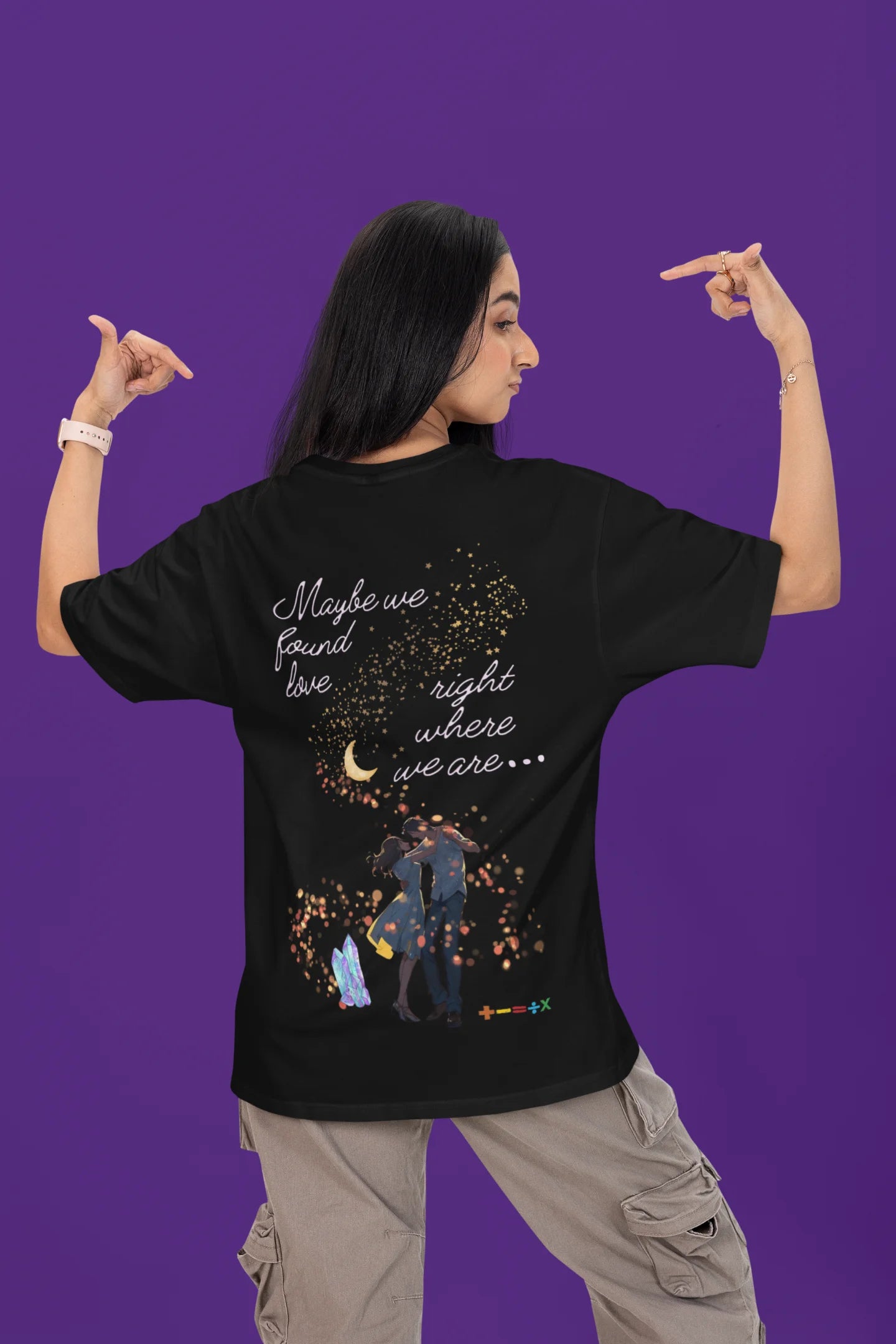 Back view of a female model wearing a black oversized t-shirt featuring a couple dancing in the moonlight, inspired by Ed Sheeran's themes of love.