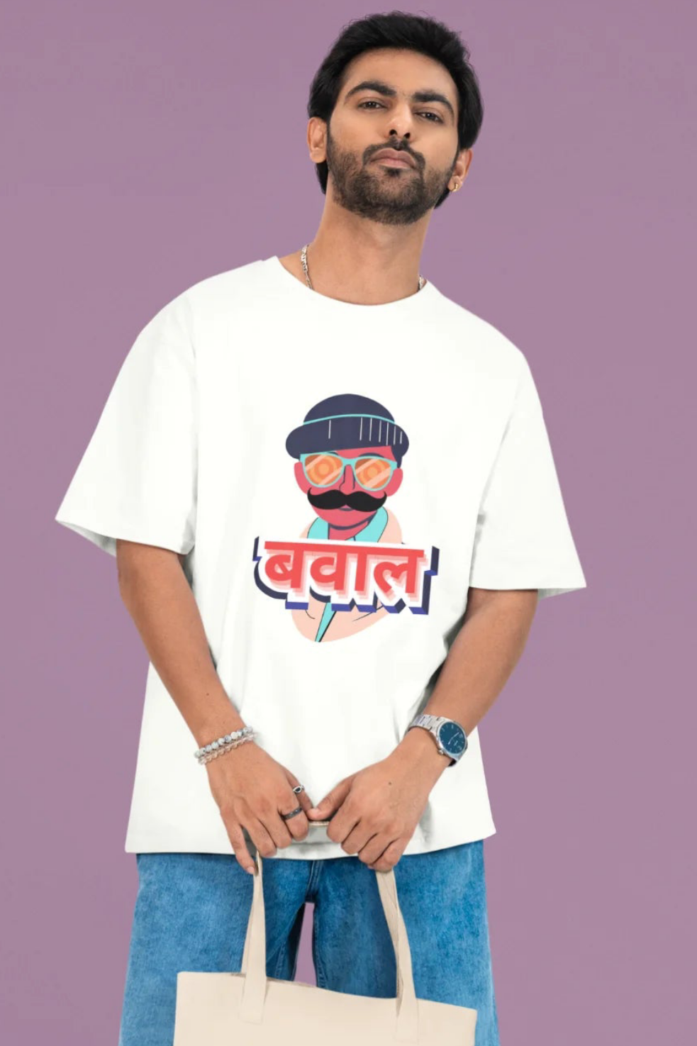 First front view of a male model wearing a off-white oversized t-shirt with "Bawaal" in a stylish Hindi.