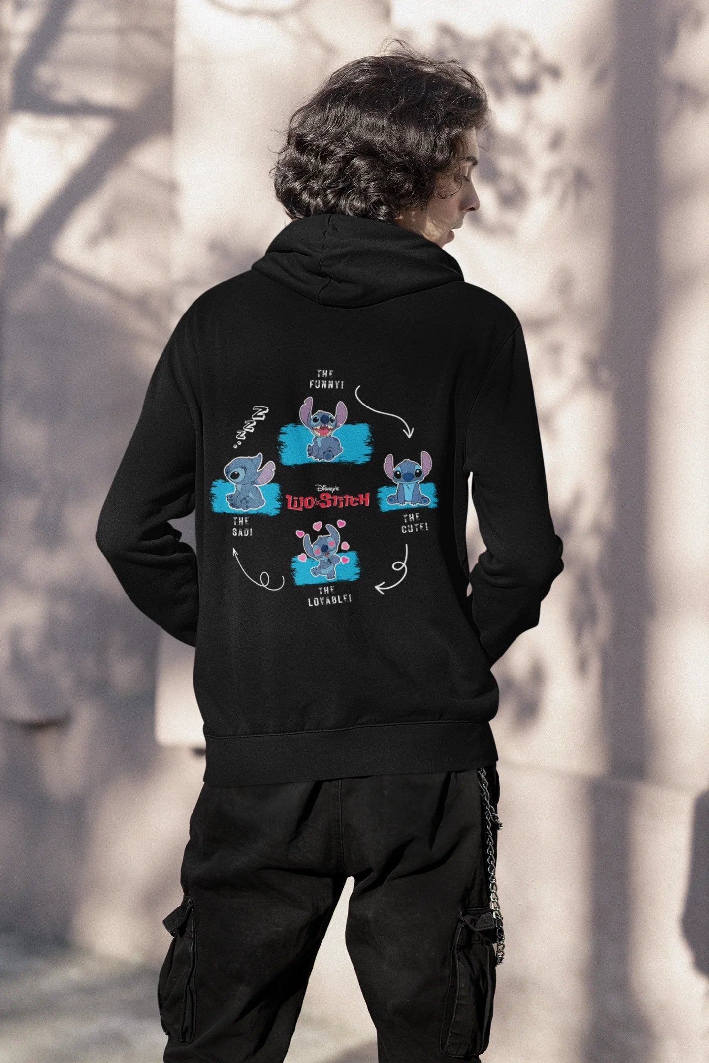 Back view of a male model wearing a black hoodie with a collage of Stitch images. The illustration shows Stitch in different poses, making various funny faces and expressions.
