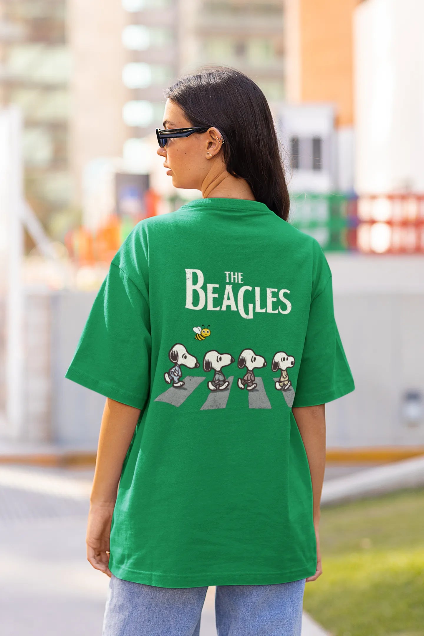 Back view of female Model showcasing forest green oversized tee with a The Beagles animated series themed design, featuring the cool canine quartet from ourt disney collection of oversized tees.