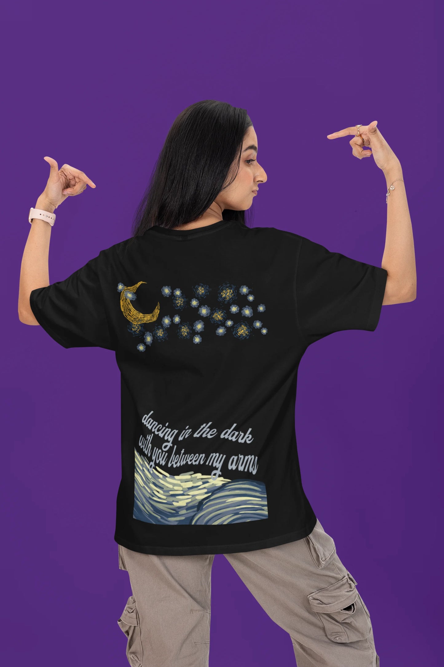 Back view of a female model wearing a black oversized t-shirt featuring lyrics from Ed Sheeran's song "Perfect" against a night sky design.