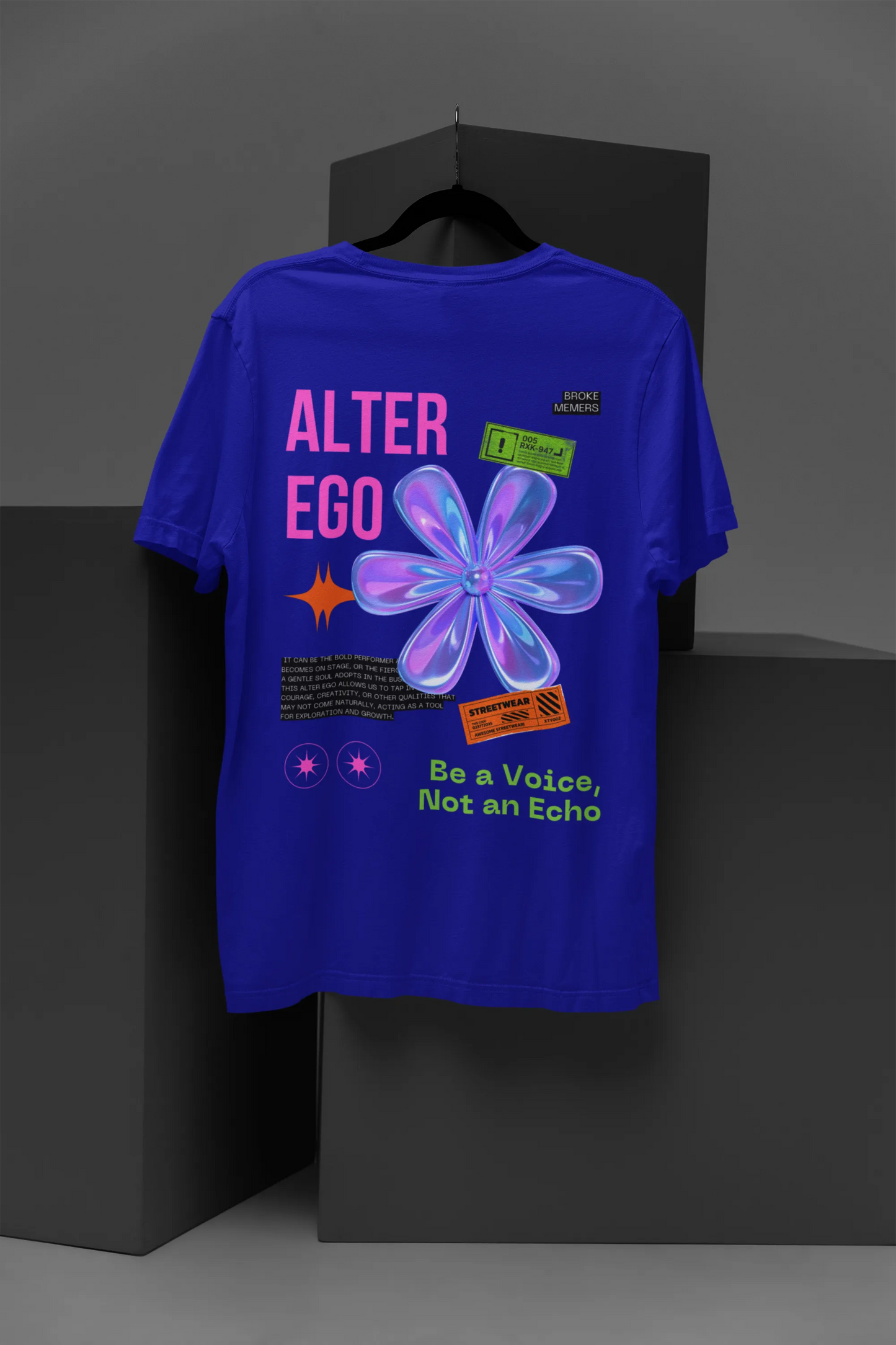 Back view of a royal blue oversized t-shirt with a metal flower design and "Be a Voice, Not an Echo" slogan.