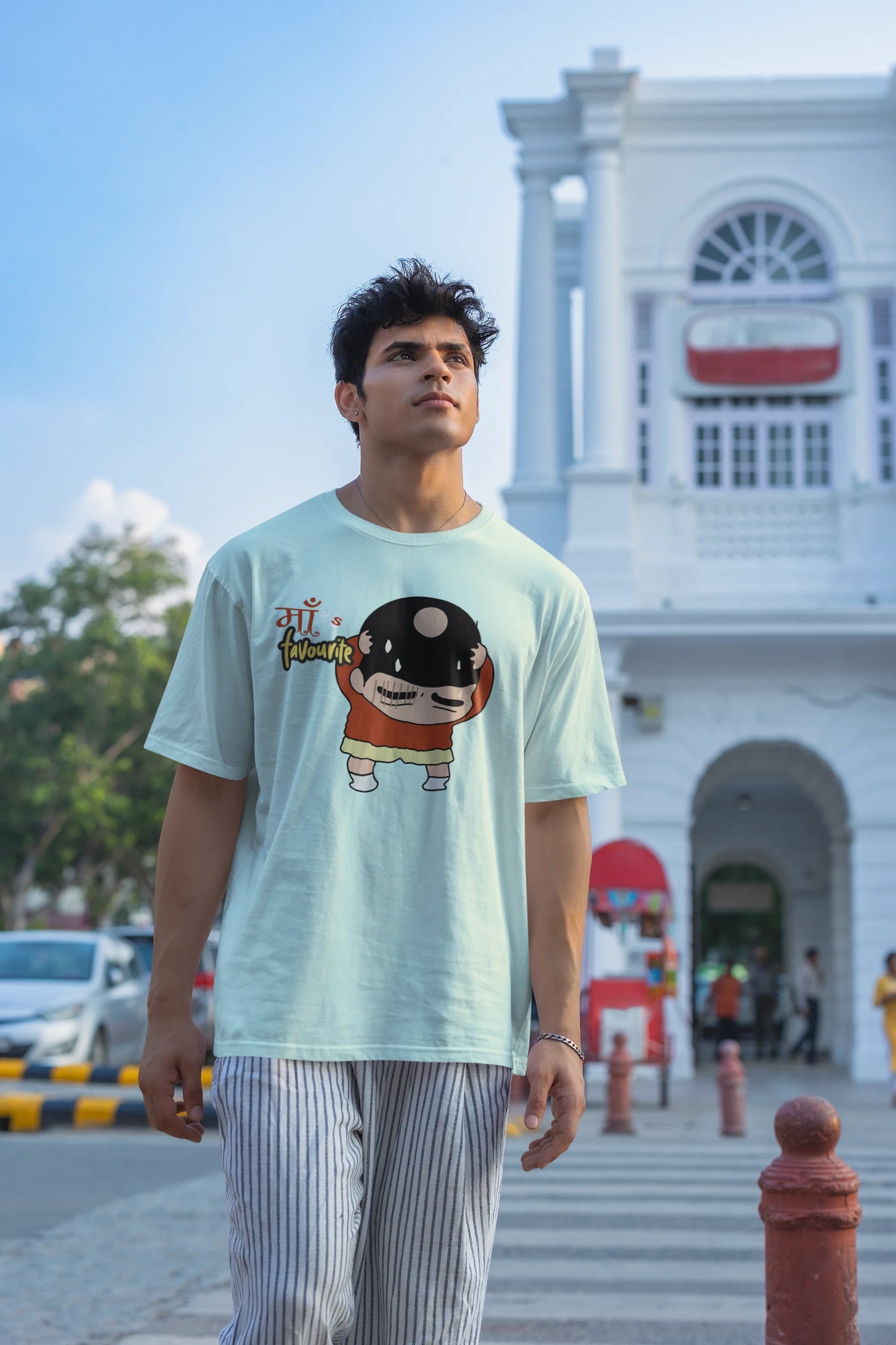 Second front view of male model wearing a mint green oversized tee featuring Shinchan with a classic bump on his head. A perfect blend of humor and nostalgia for Shinchan fans.