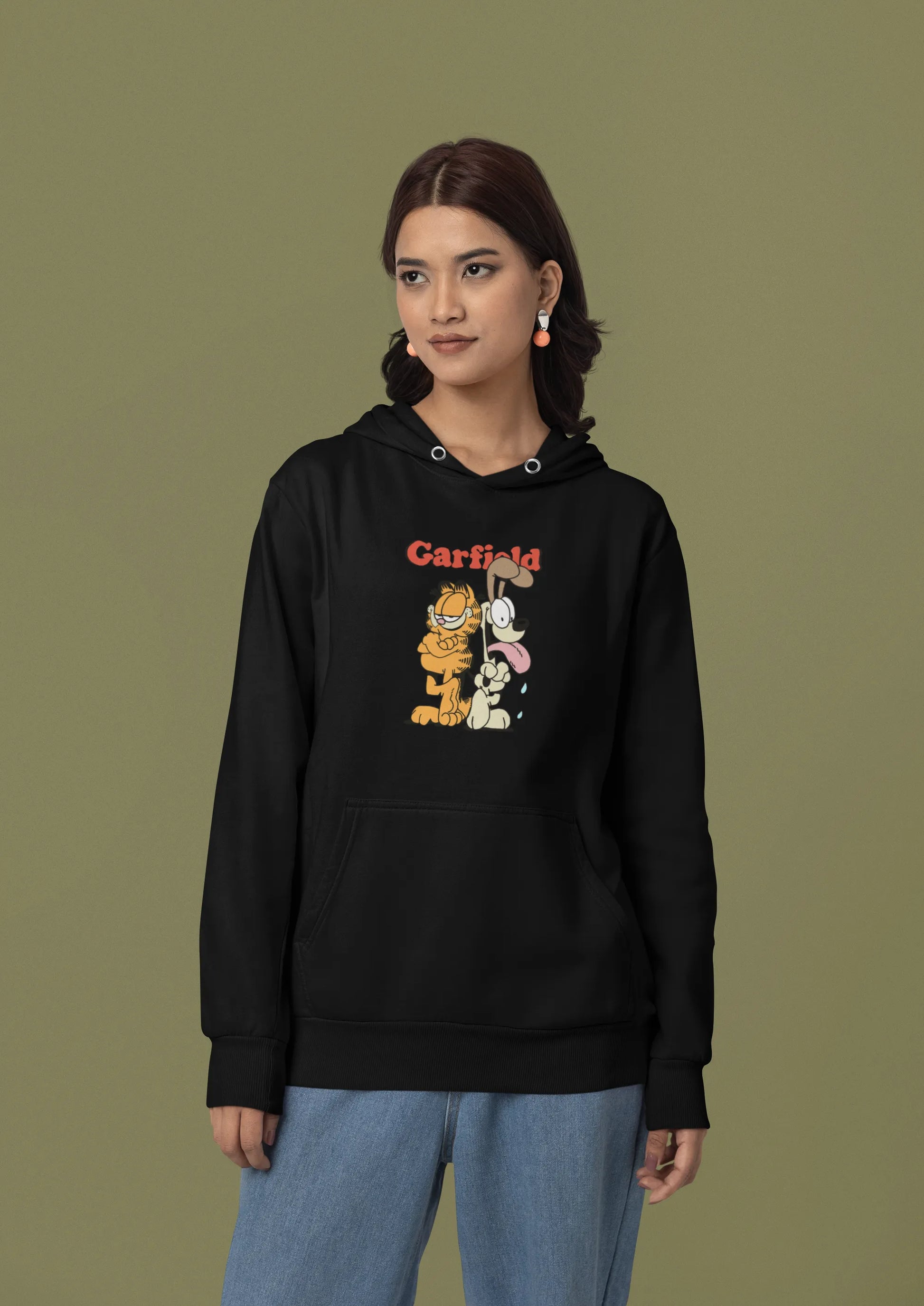 Third front view of a female model wearing a black hoodie with a Garfield illustration showing the cat standing back to back with Odie, surrounded by a playful cartoon border.