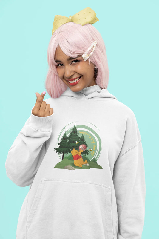 Close up front view of a female model wearing a off-white 
hoodie with a Winnie the Pooh design, showing the Disney bear eating honey from a jar in a forest.