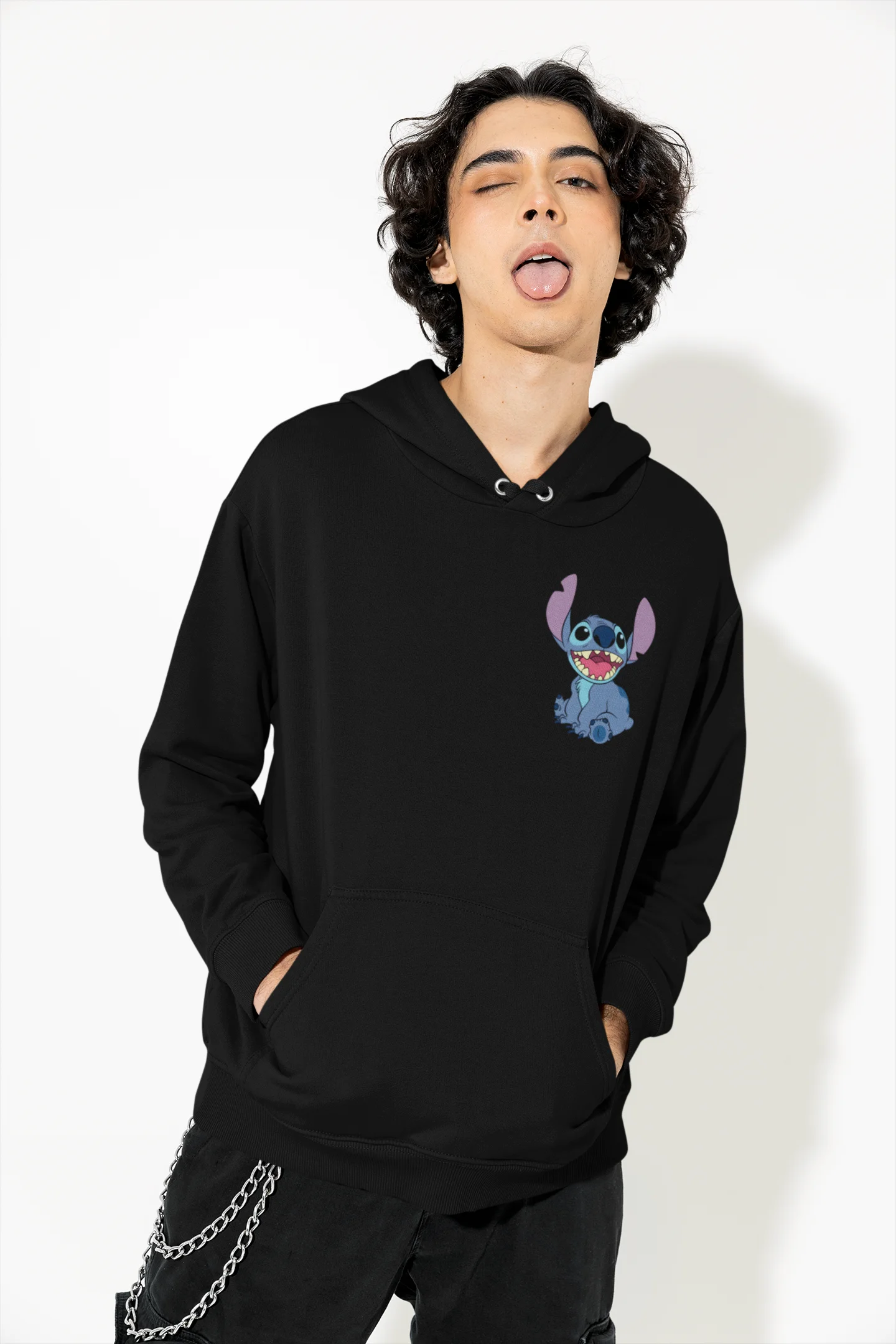 Front view of a female model wearing a black hoodie with a collage of Stitch images. The illustration shows Stitch in different poses, making various funny faces and expressions.