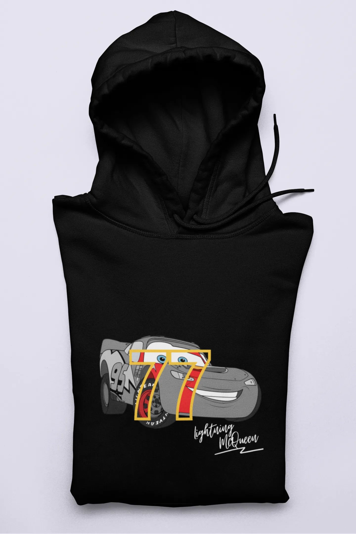 Close up front view of a black hoodie with a Disney Cars design featuring Lightning McQueen and the number 77.