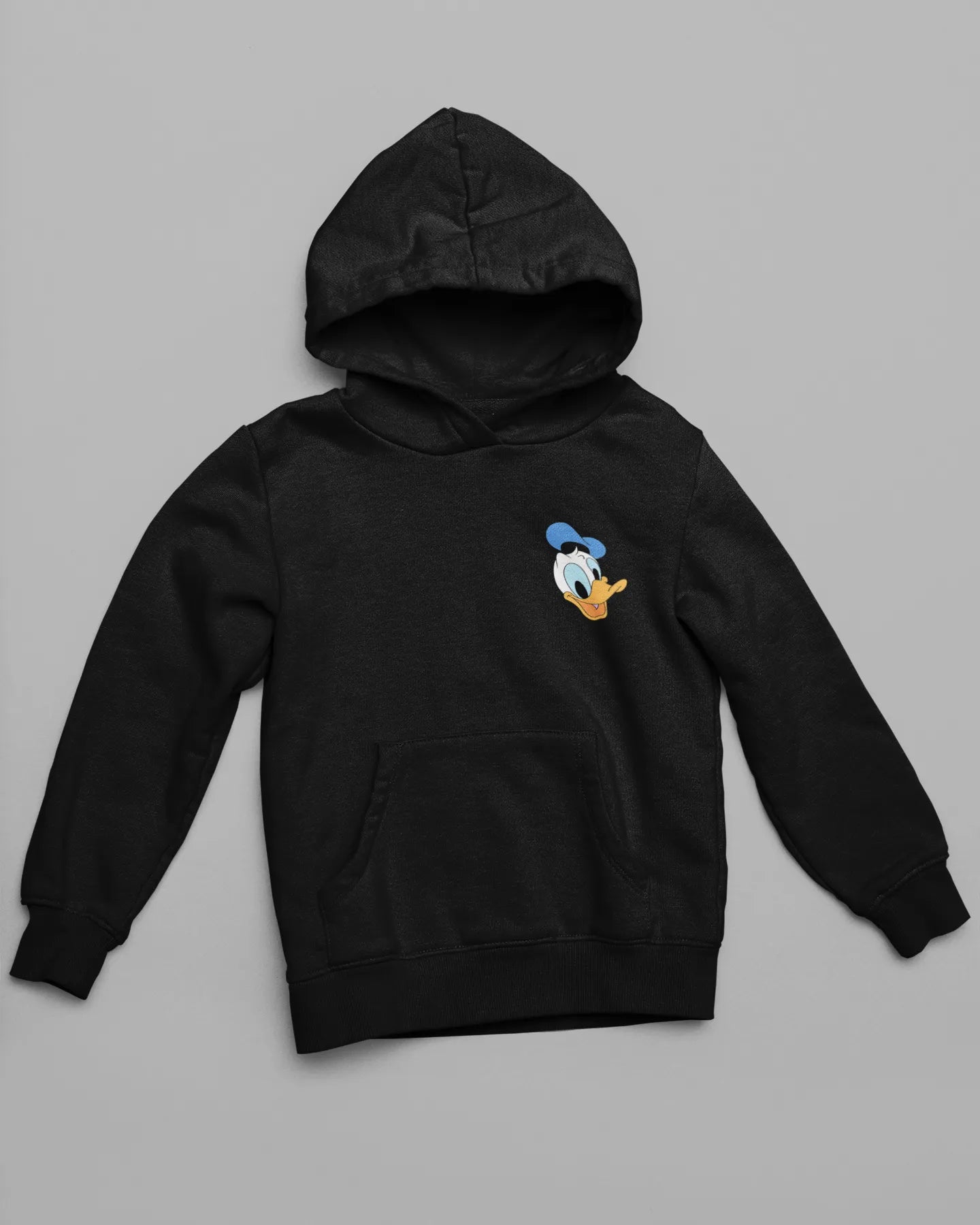Front view of a black hoodie with a Disney Donald Duck design, showing him rubbing his head after a mishap.