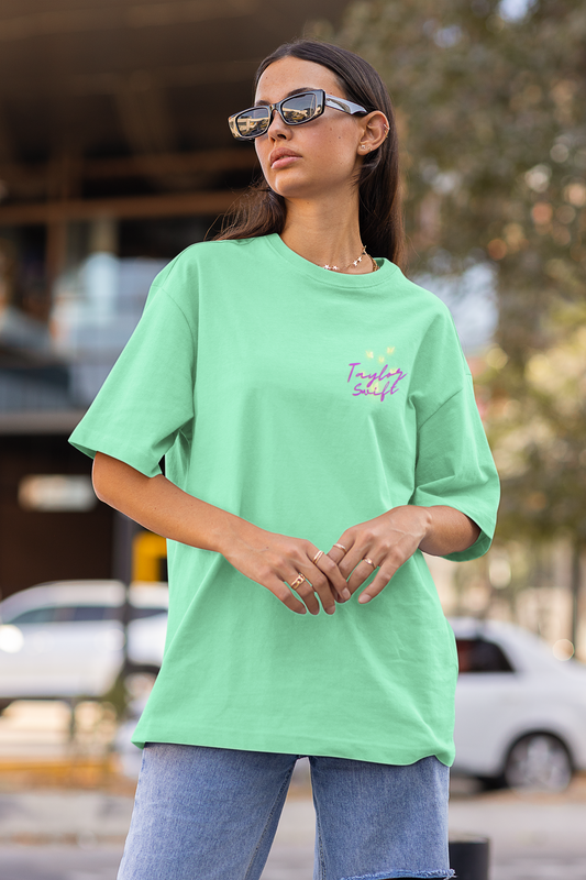 Side view of female model showcasing mint green oversized Taylor Swift t-shirts inspired by her "Lover" album (Taylor's Version).