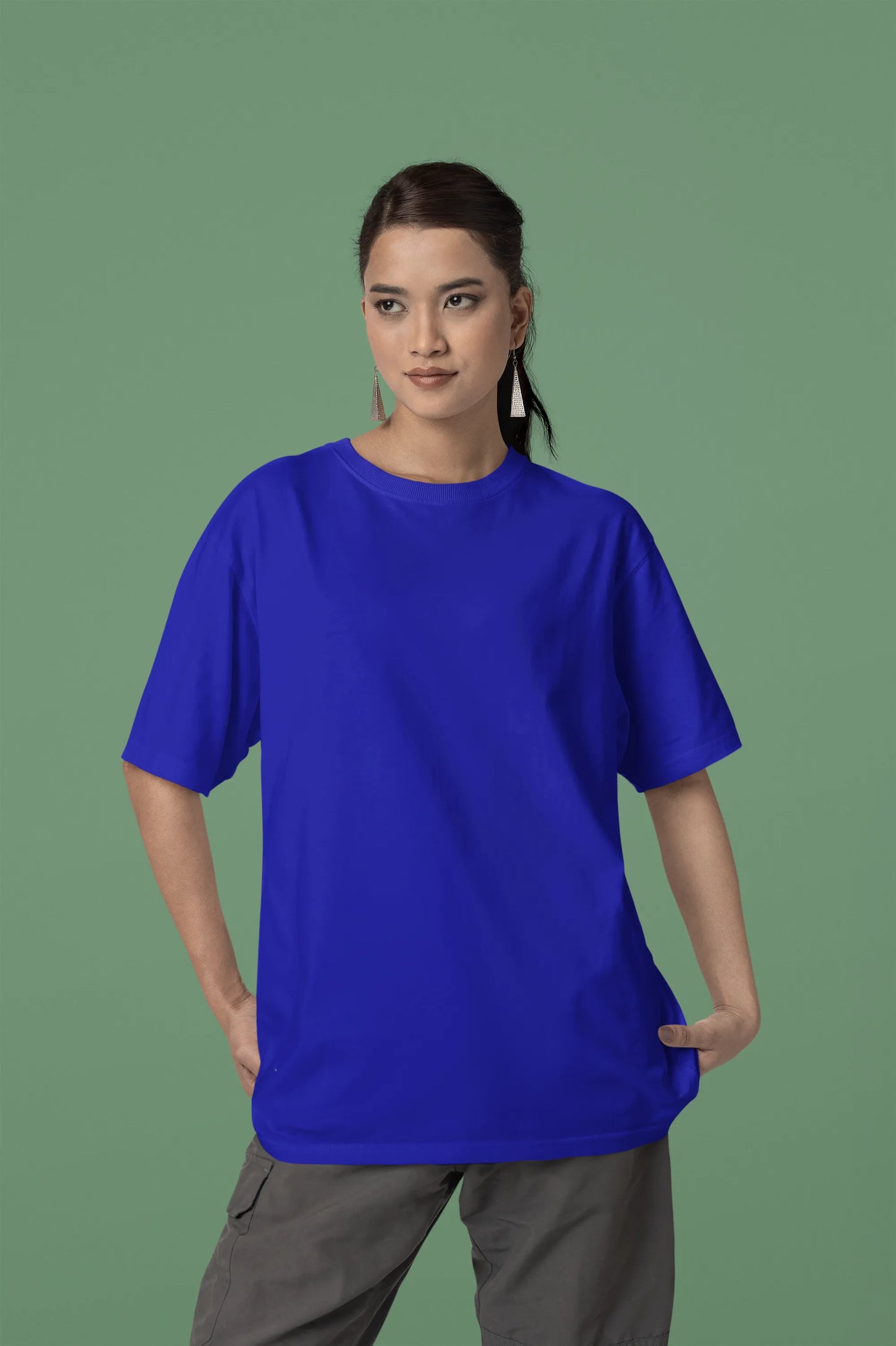 Front view of a female model wearing a royal blue oversized t-shirt with a metal flower design and "Be a Voice, Not an Echo" slogan.