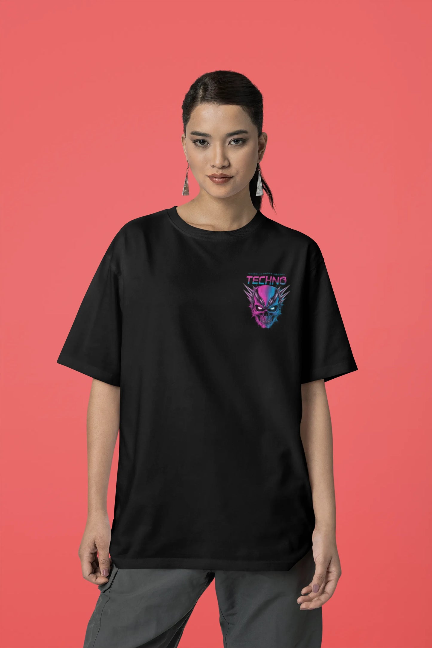 Third front view of a female model wearing an black oversized t-shirt with a stylized Techno Skull design, perfect for rave and party vibes.
