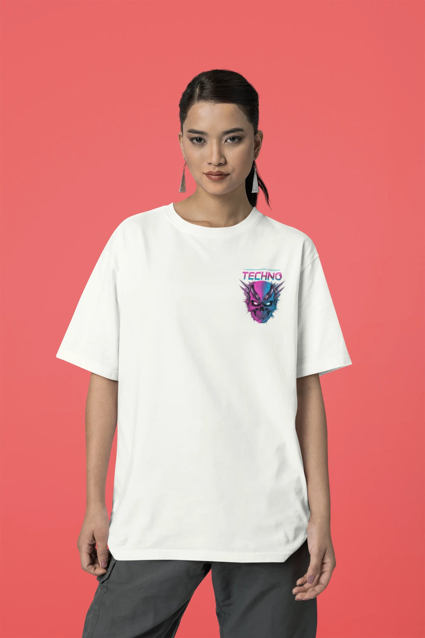 First front view of a female model wearing an off-white oversized t-shirt with a stylized Techno Skull design, perfect for rave and party vibes.