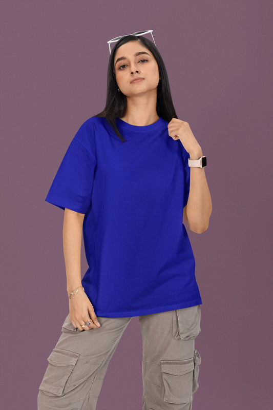First front view of a female model wearing a royal blue oversized t-shirt featuring a couple dancing in the moonlight, inspired by Ed Sheeran's themes of love.