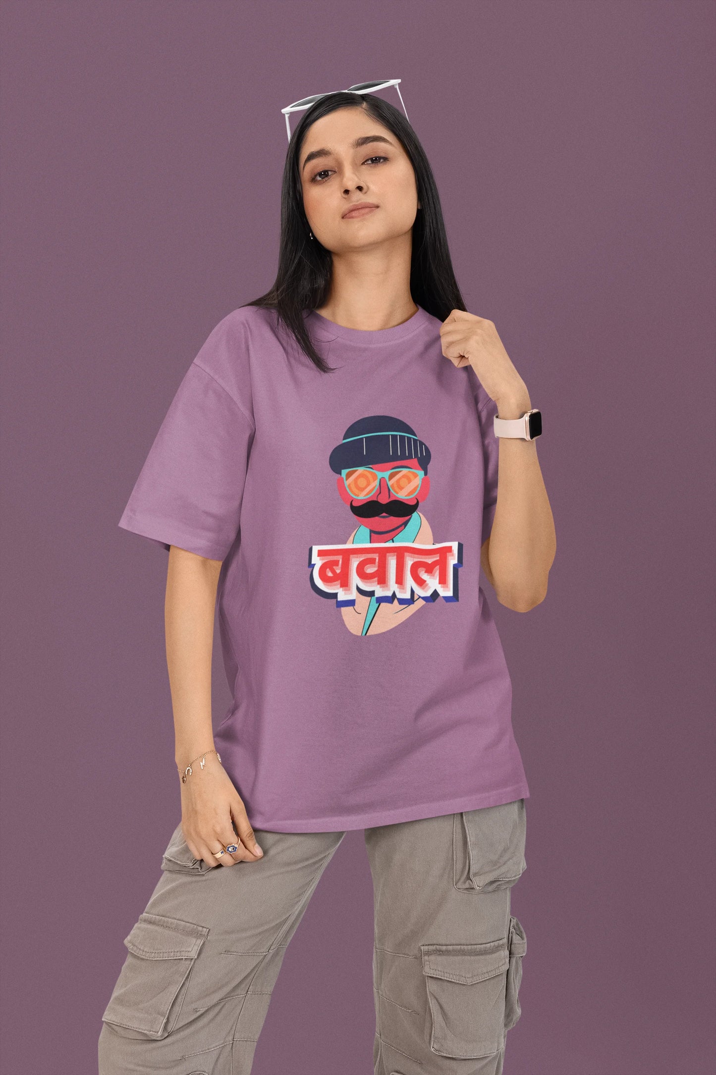3rd front view of a female model wearing a dirty purple oversized t-shirt with "Bawaal" in a stylish Hindi.