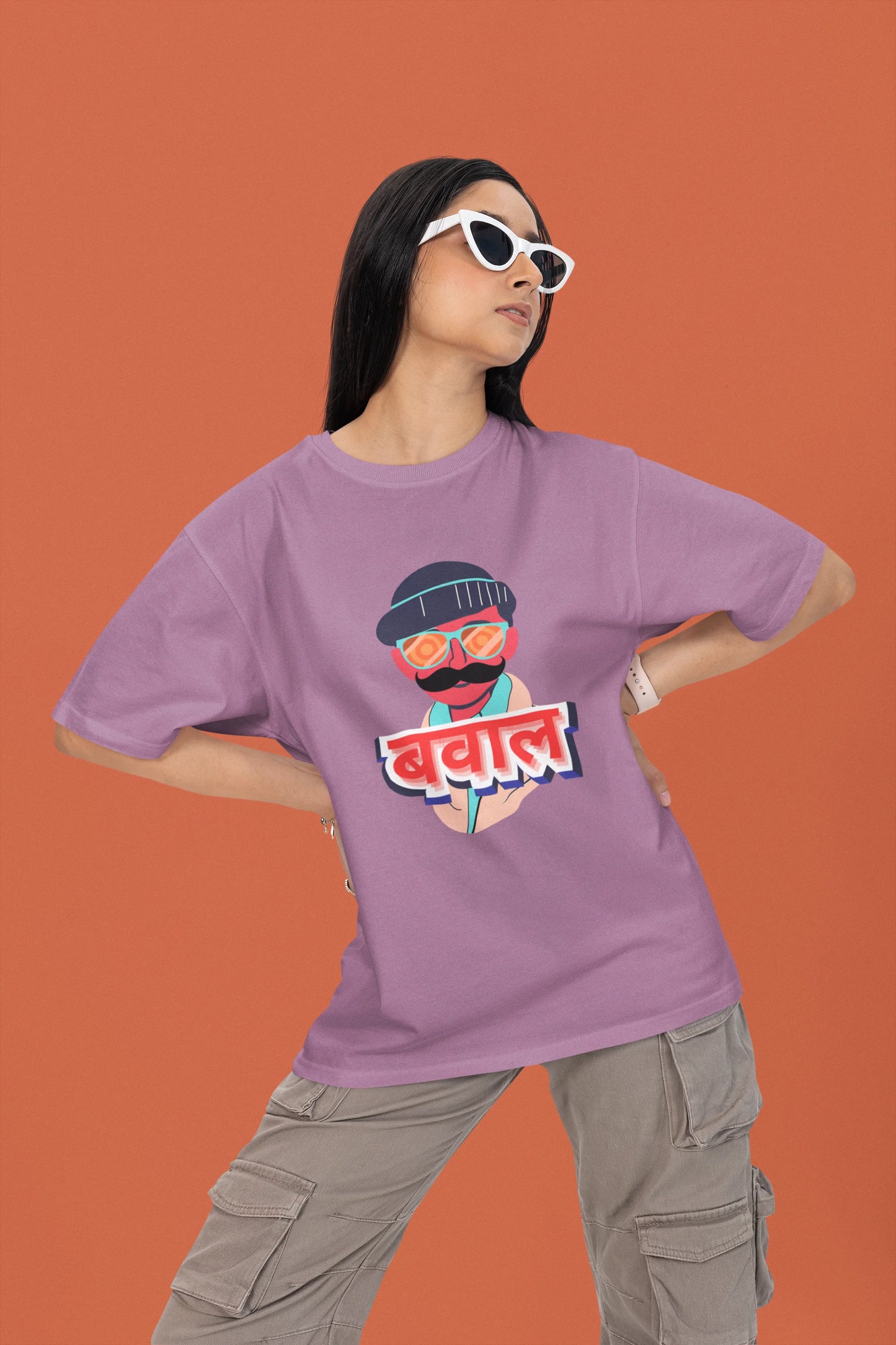 2nd front view of a female model wearing a dirty purple oversized t-shirt with "Bawaal" in a stylish Hindi.