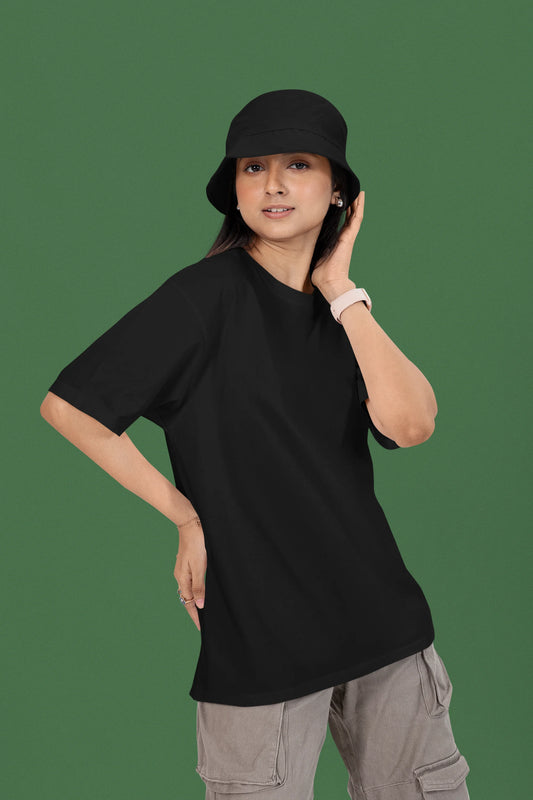 First front view of a female model wearing a black oversized t-shirt featuring a couple dancing in the moonlight, inspired by Ed Sheeran's themes of love.