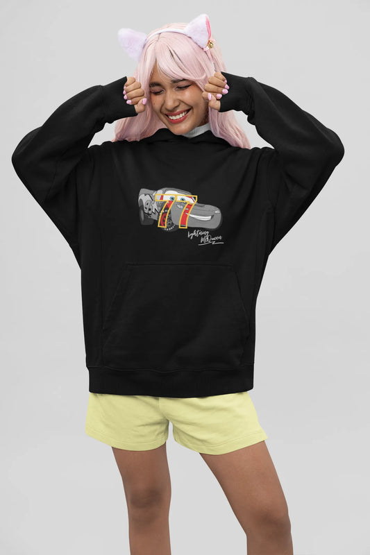 Front view of a female model wearing a black hoodie with a Disney Cars design featuring Lightning McQueen and the number 77.