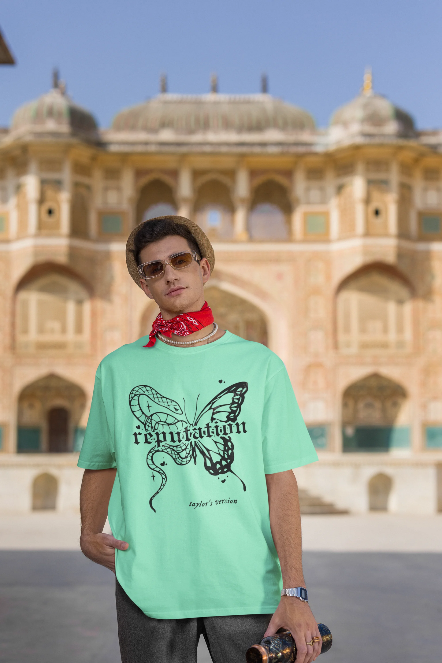 Third Image of a man wearing mint green Oversize t-shirt featuring Reputation Taylor's Version design inspired by Taylor Swift's Reputation era