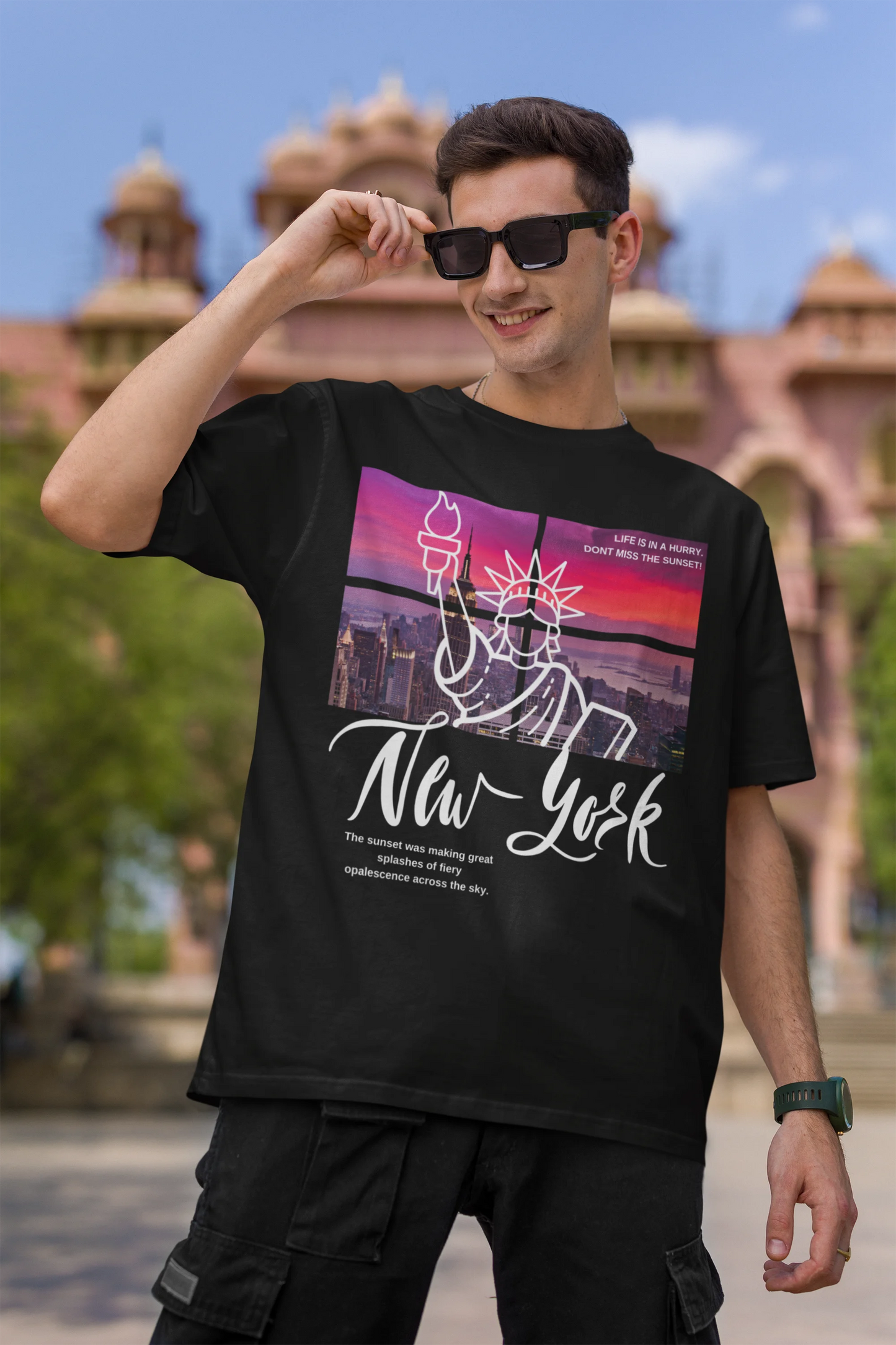 First front view of a male model wearing a black oversized t-shirt with a New York City skyline design, offering a relaxed urban aesthetic.