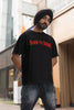 Third front image of a male model wearing a black oversized t-shirt featuring a Diljit Dosanjh-inspired design with the text 