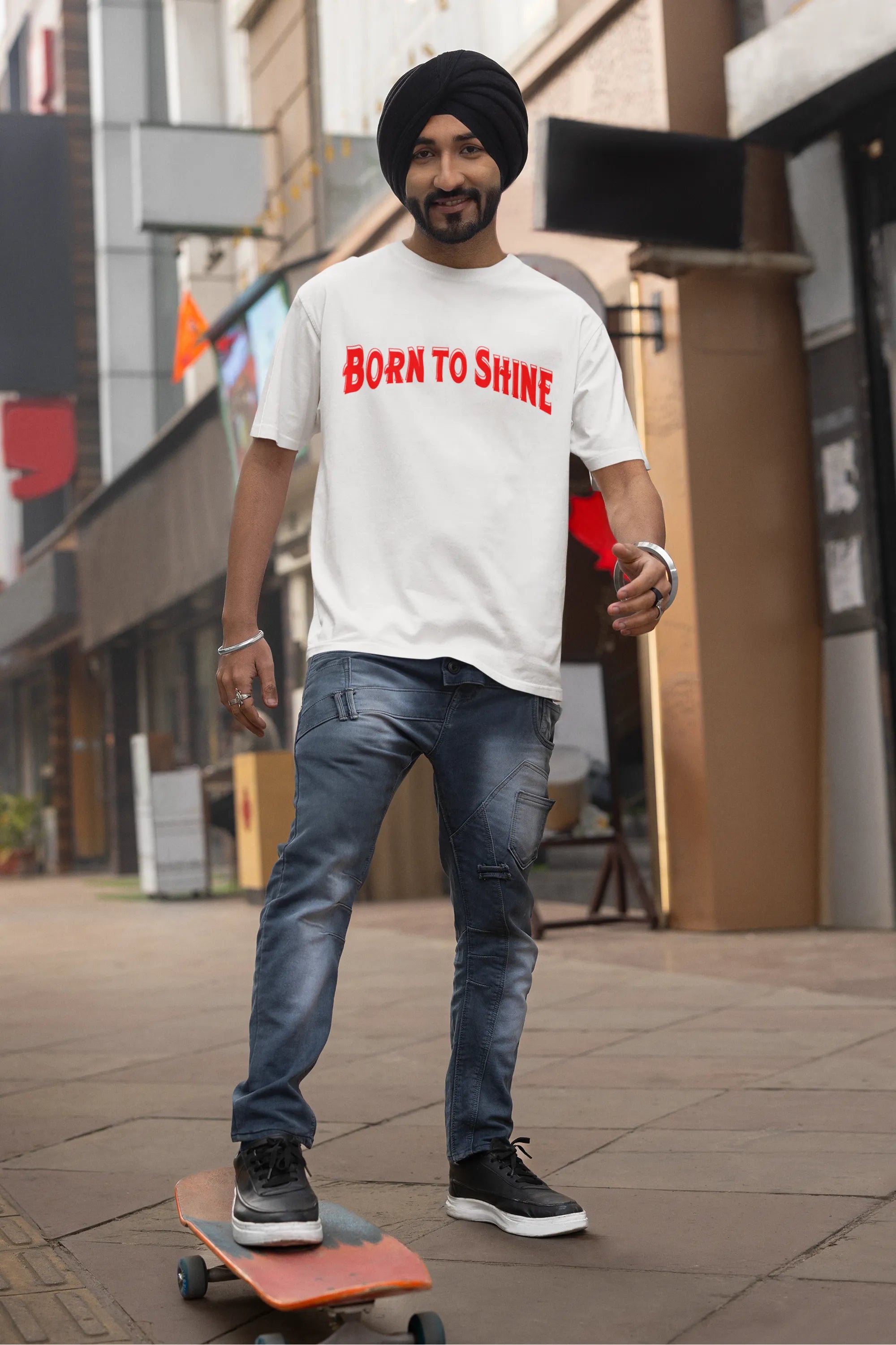 First front image of a male model wearing a off-white oversized t-shirt featuring a Diljit Dosanjh-inspired design with the text "Born to Shine."
