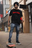 First front image of a male model wearing a black oversized t-shirt featuring a Diljit Dosanjh-inspired design with the text 