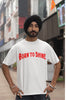 Fourth front image of a male model wearing a off-white oversized t-shirt featuring a Diljit Dosanjh-inspired design with the text 