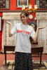 First front image of a female model wearing a off-white oversized t-shirt featuring a Diljit Dosanjh-inspired design with the text 
