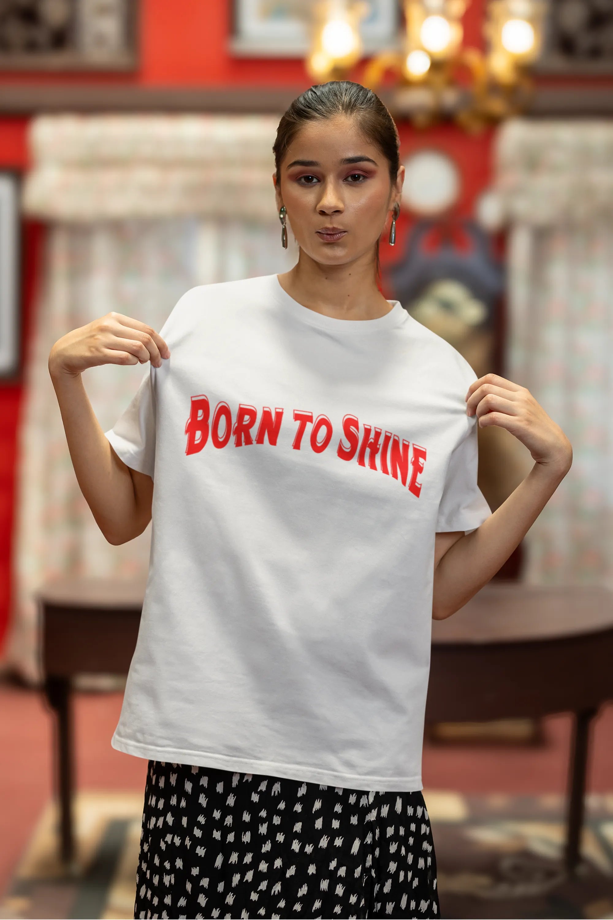 Third front image of a female model wearing a off-white oversized t-shirt featuring a Diljit Dosanjh-inspired design with the text "Born to Shine."
