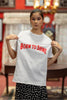 Third front image of a female model wearing a off-white oversized t-shirt featuring a Diljit Dosanjh-inspired design with the text 