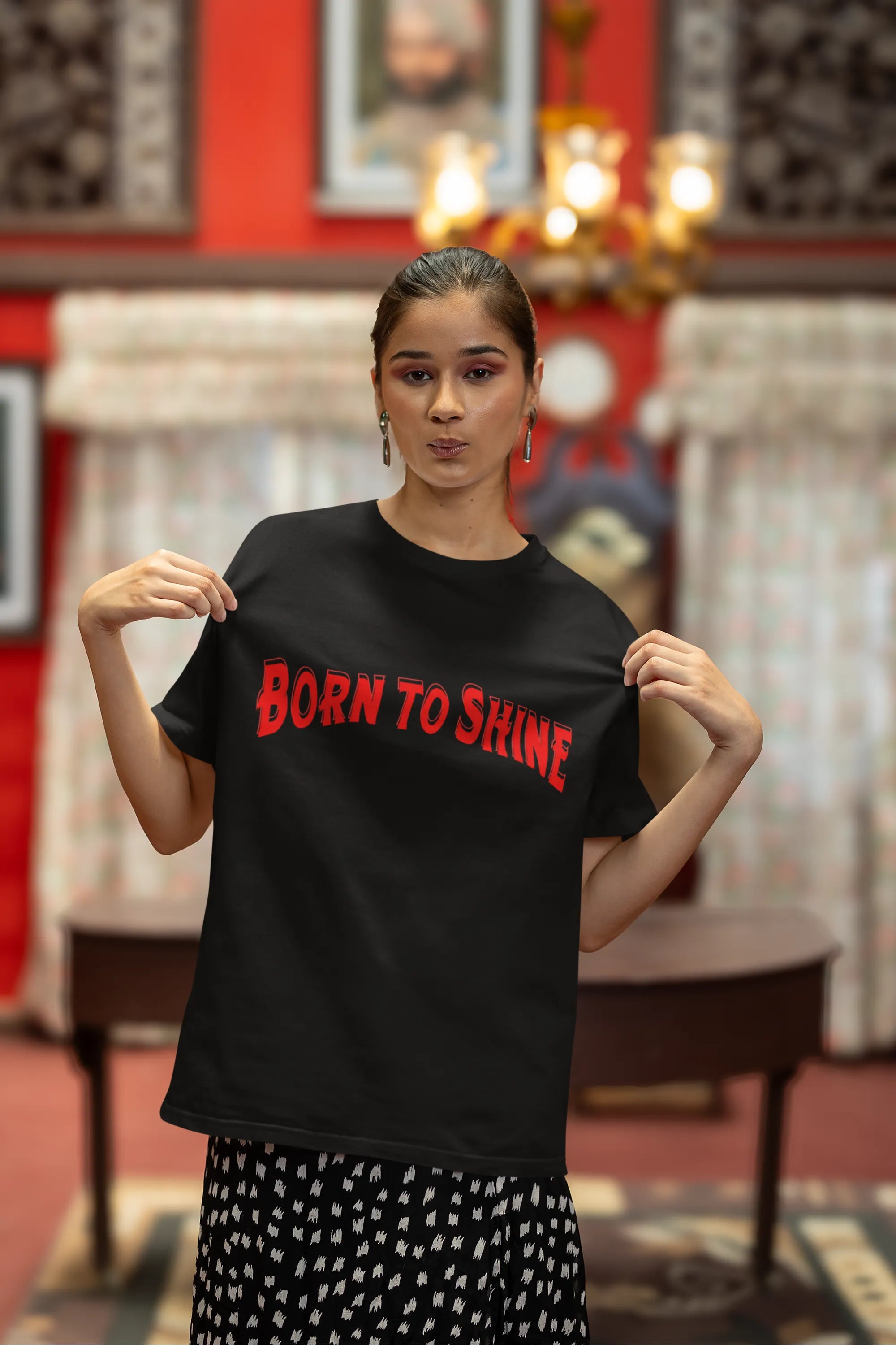 Third front image of a female model wearing a black oversized t-shirt featuring a Diljit Dosanjh-inspired design with the text "Born to Shine."