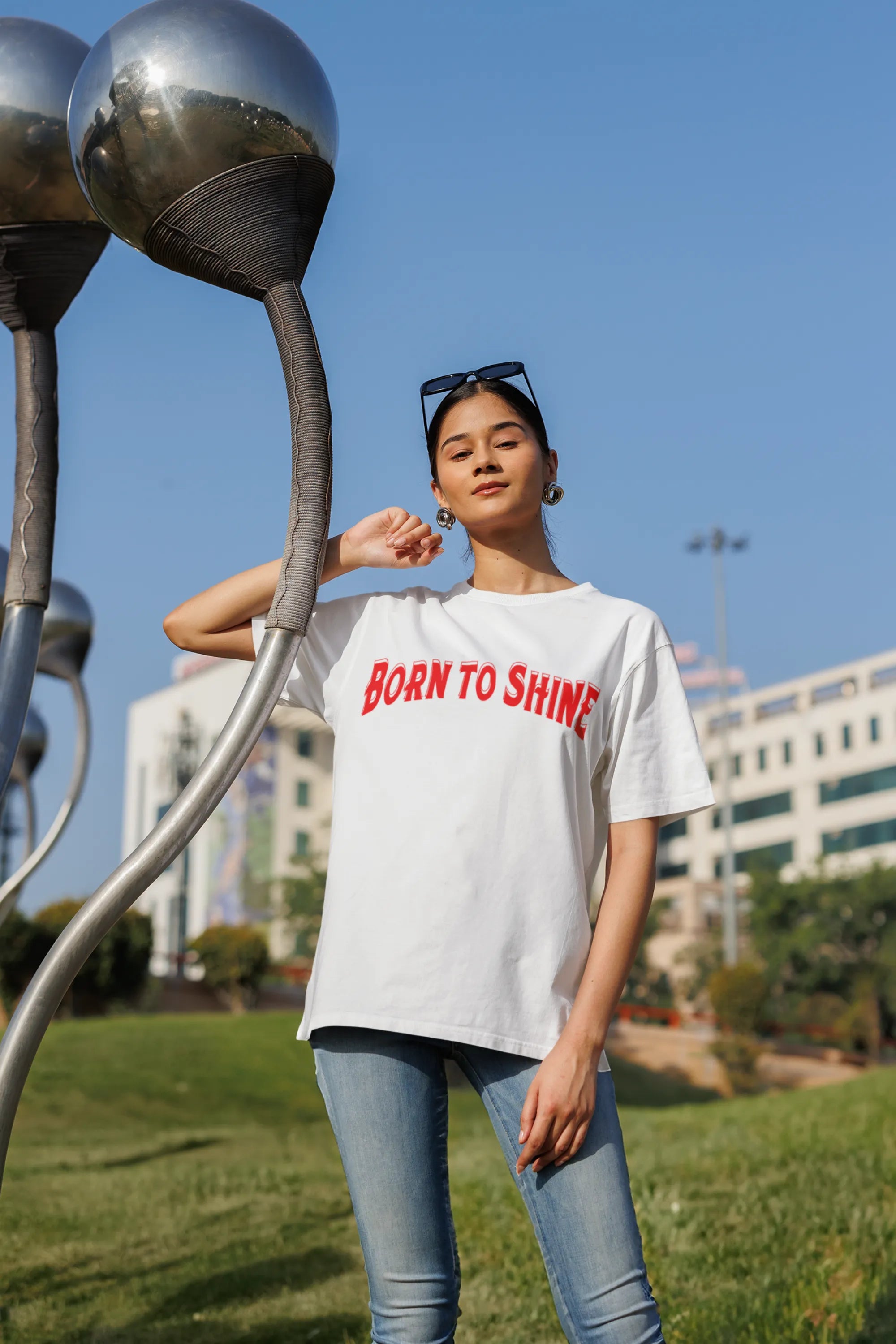 Second front image of a female model wearing a off-white oversized t-shirt featuring a Diljit Dosanjh-inspired design with the text "Born to Shine."
