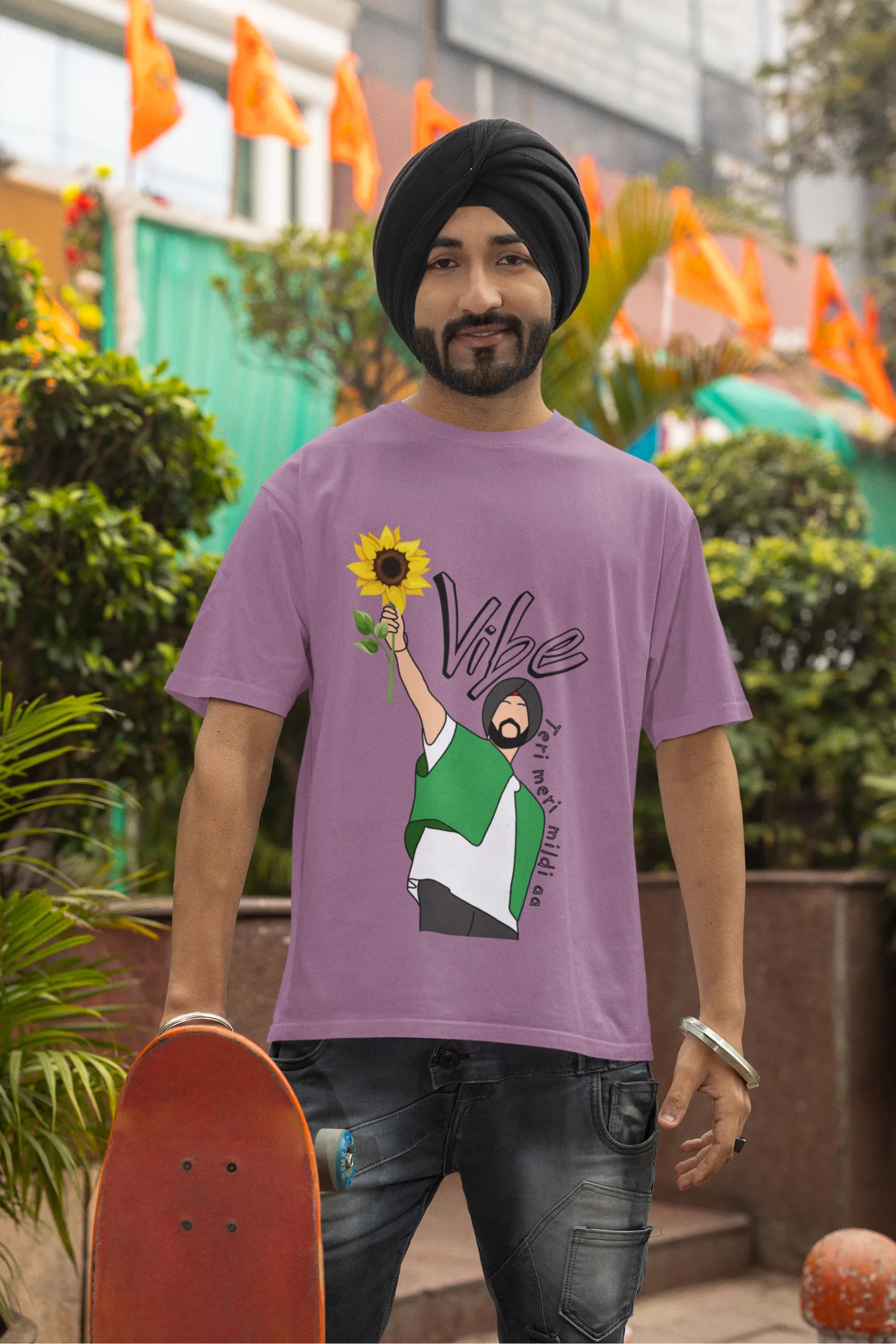 Second front view of male model wearing a dirty purple oversized t shirt with a design of Diljit Dosanjh holding a sunflower, with the text "Vibe Teri Meri".