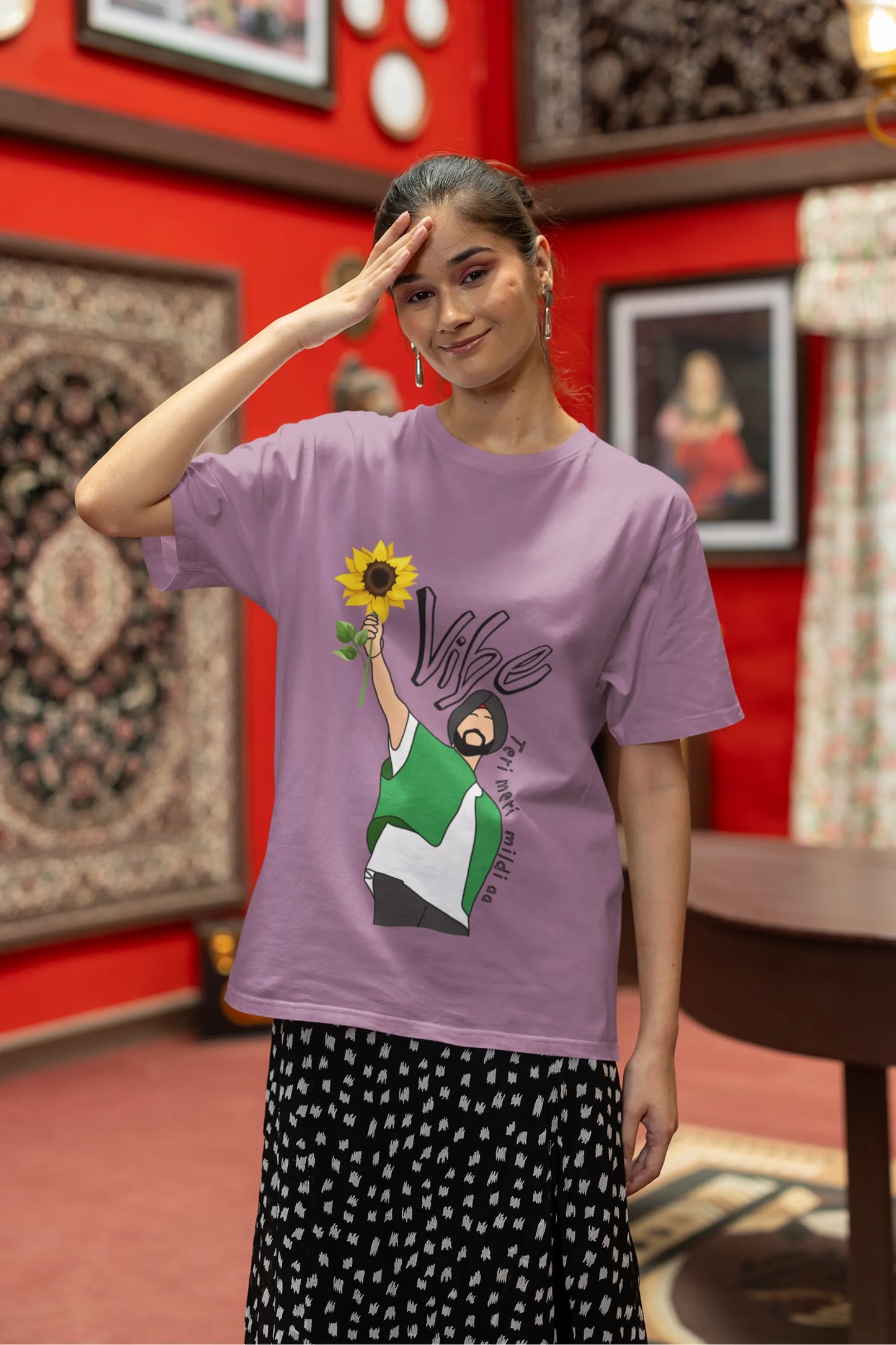 First front view of female model wearing a dirty purple oversized t shirt with a design of Diljit Dosanjh holding a sunflower, with the text "Vibe Teri Meri".