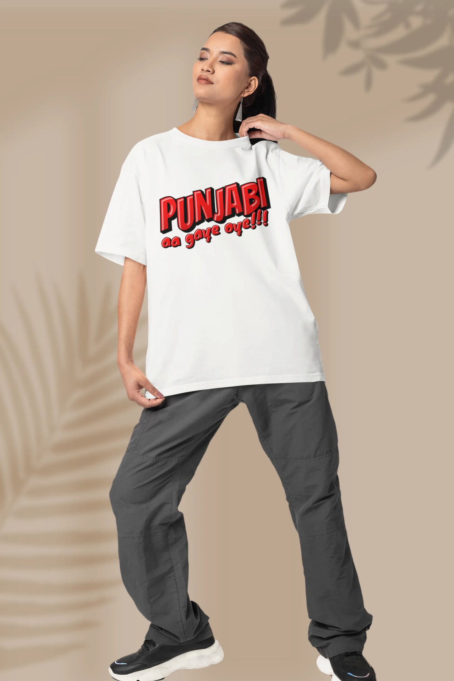 Second front view of a female model wearing an off-white oversized t-shirt with the text "Punjabi Aa Gaye Oye".