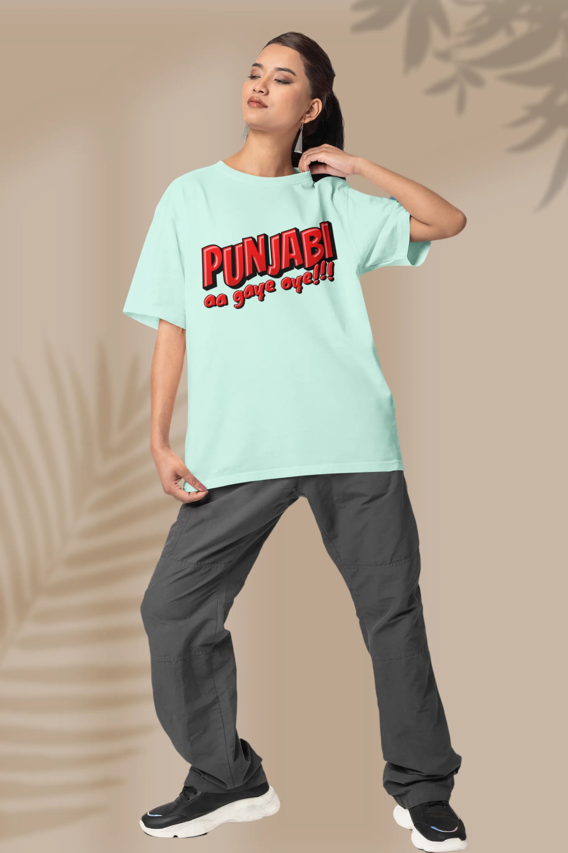 Second front view of a female model wearing an mint-green oversized t-shirt with the text "Punjabi Aa Gaye Oye".