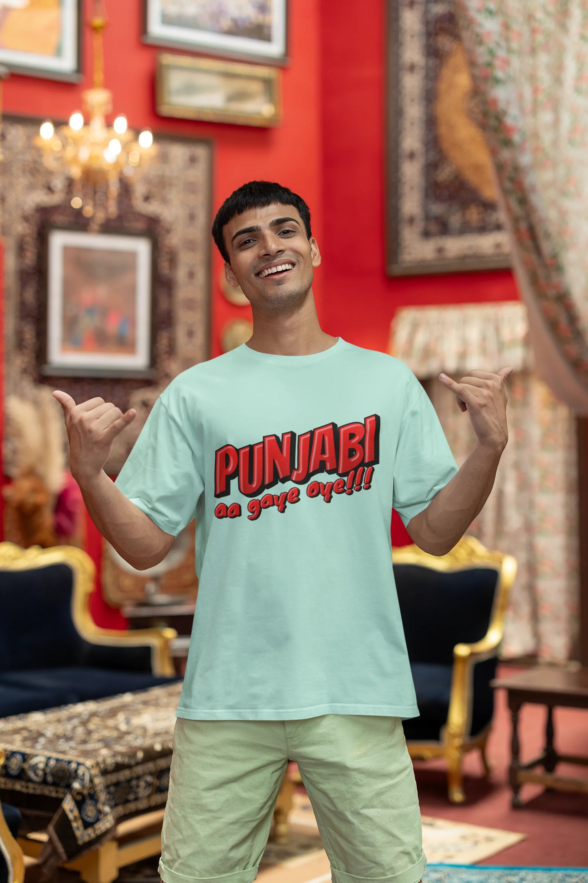 First front view of a male model wearing an mint-green oversized t-shirt with the text "Punjabi Aa Gaye Oye".
